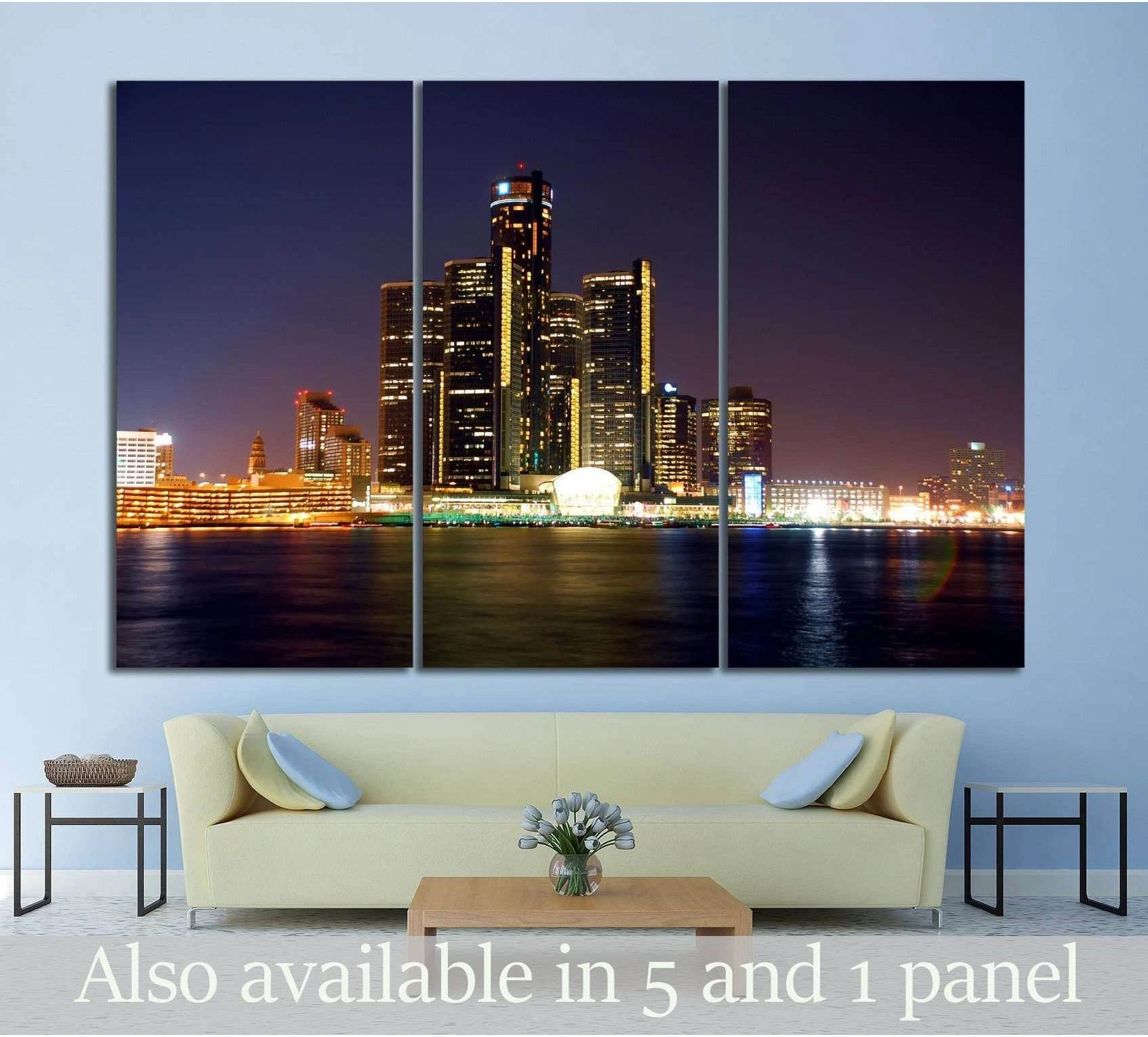 Detroit skyline triptych canvas print above sofa with dark river reflections and glowing night towers