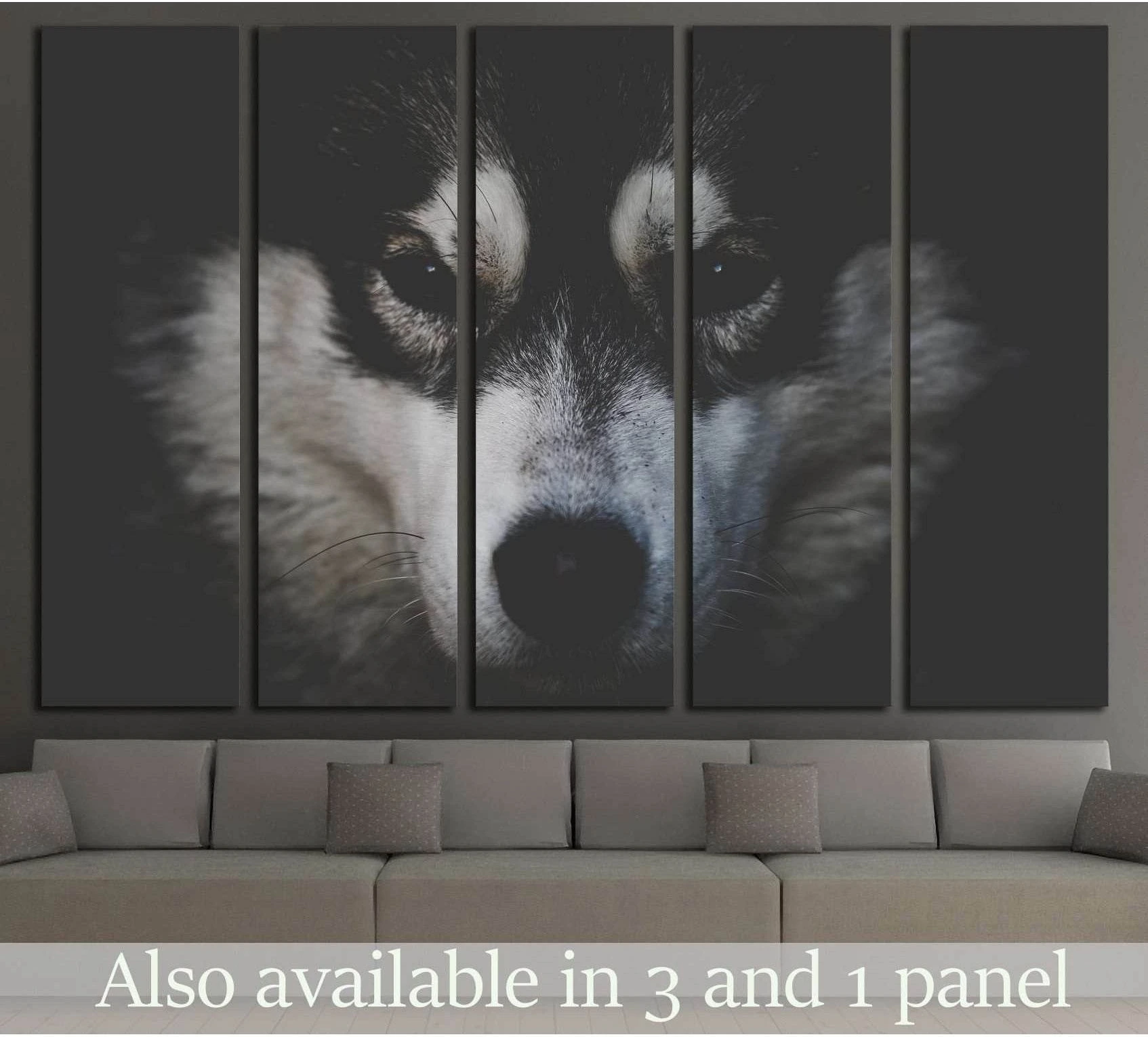 Black and white husky face canvas print displayed above sofa in a modern living room
