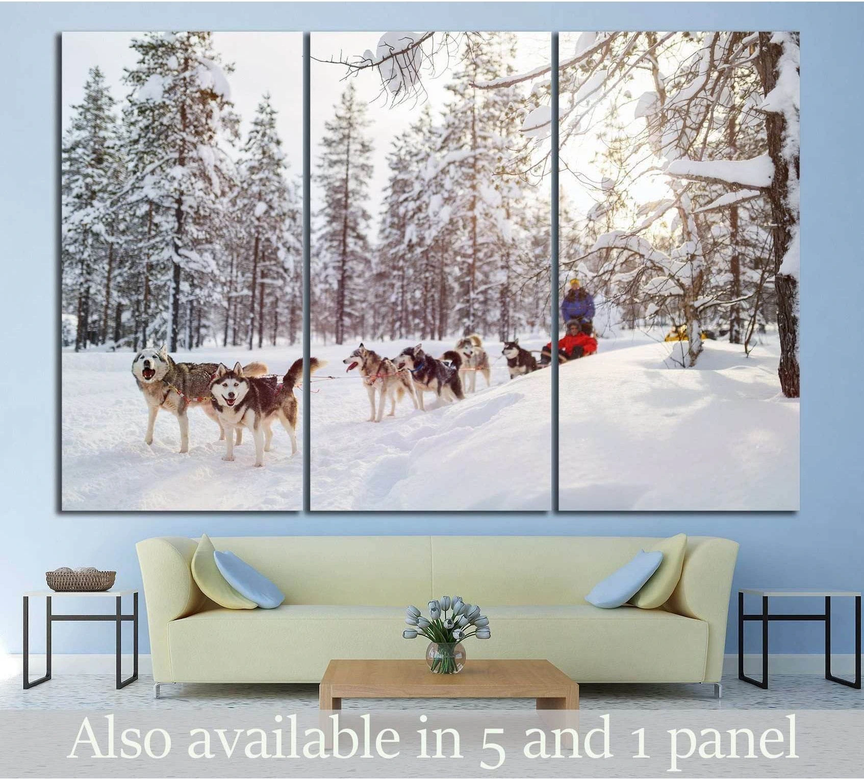 Husky sled team canvas print in a snowy pine forest, displayed as triptych wall art above a sofa