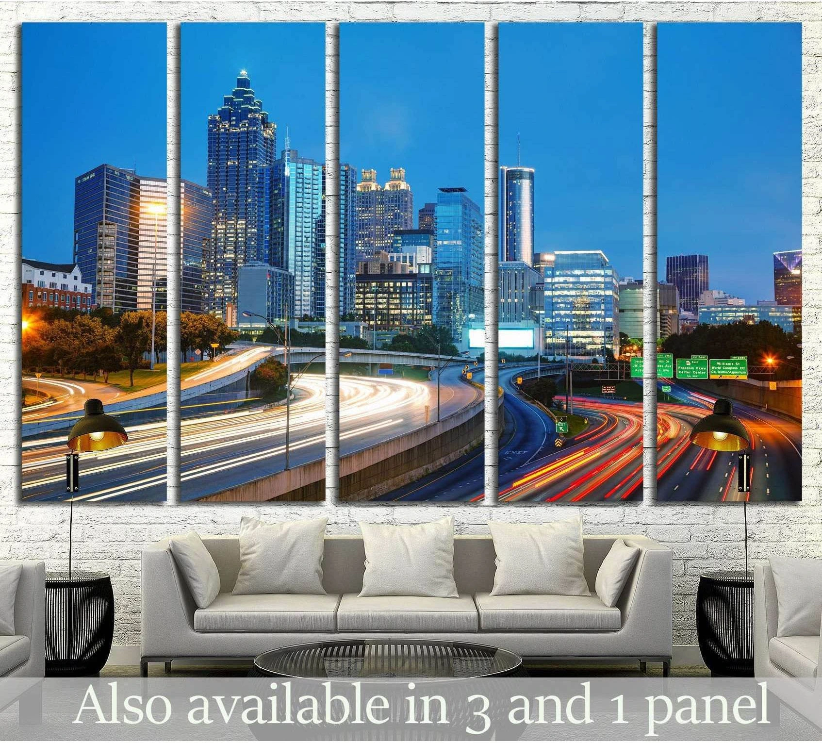 Atlanta skyline canvas print with blue hour skyscrapers and highway light trails above a sofa in a modern living room
