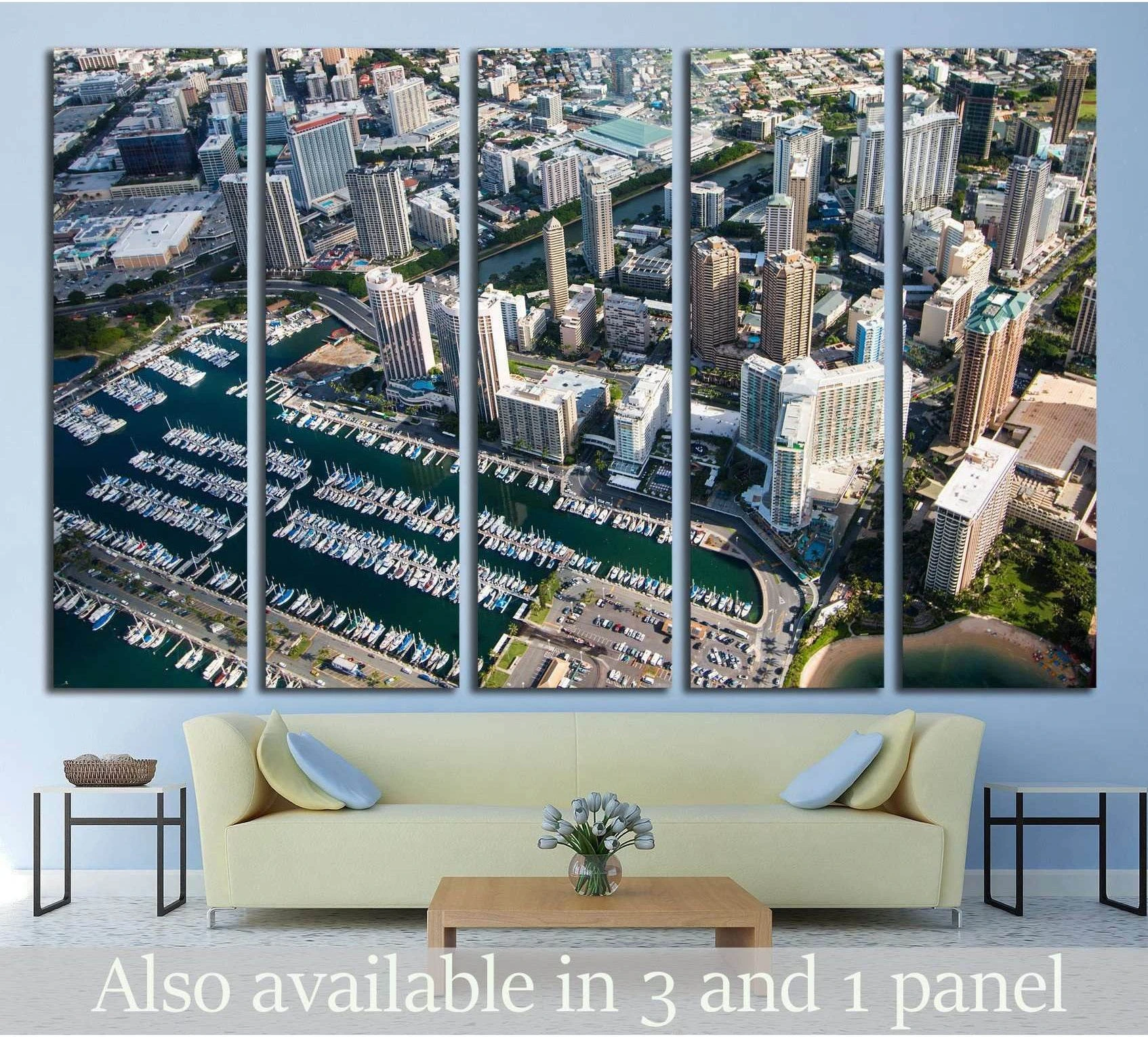 Aerial Honolulu marina and high-rise skyline canvas print hung above a sofa in a modern living room