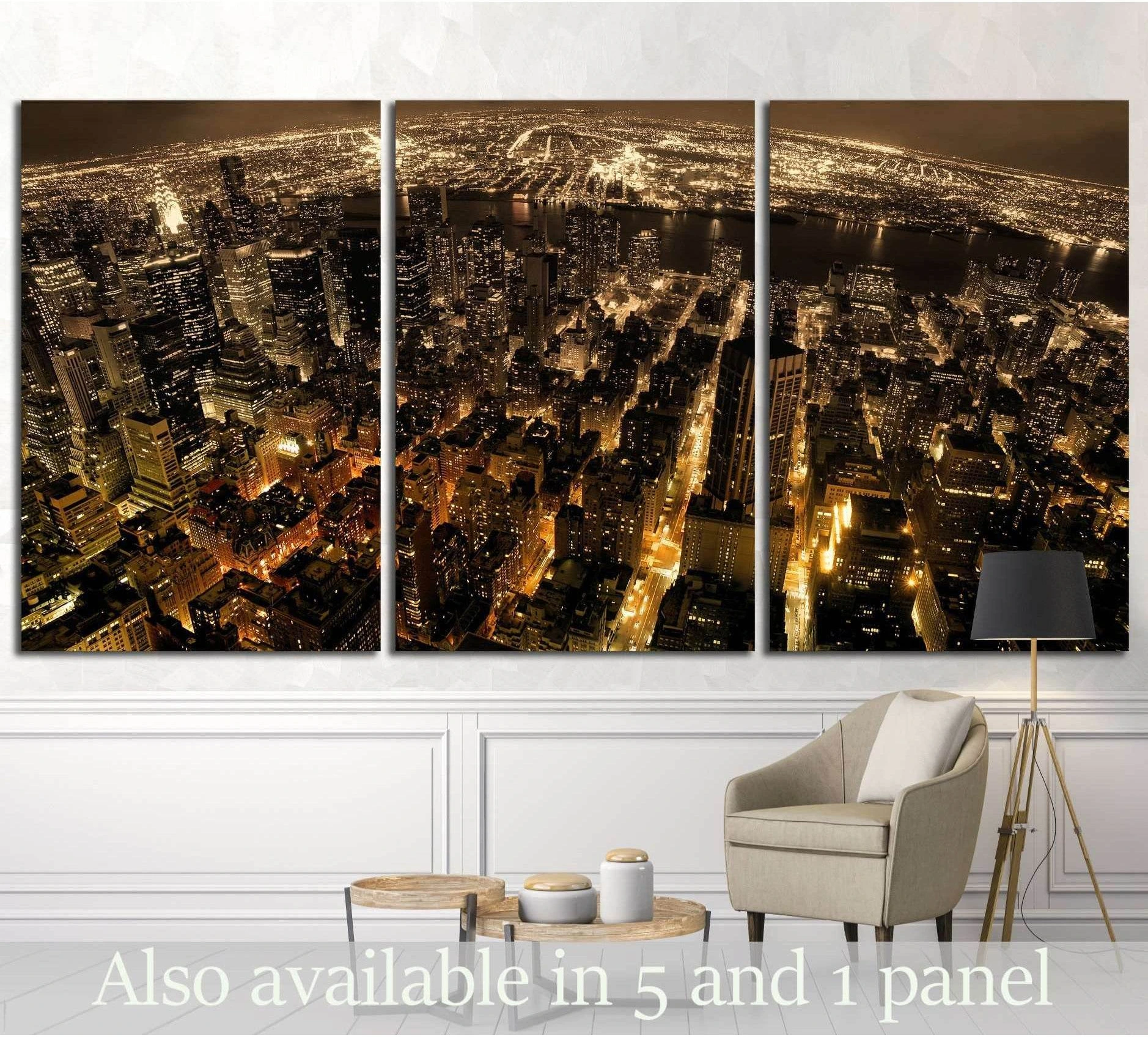 Triptych Manhattan night skyline canvas print with glowing city lights above a chair in a modern room