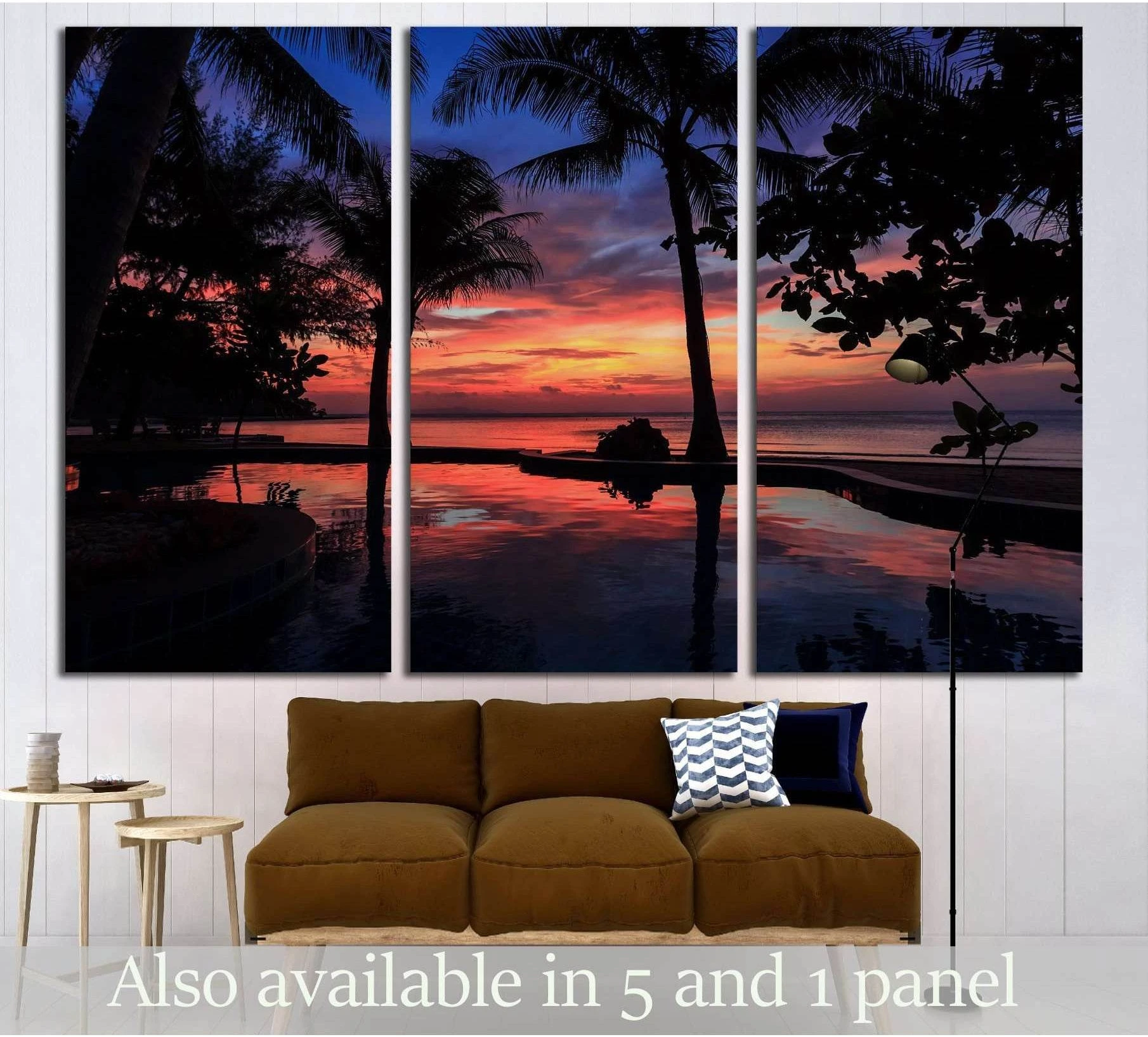 Tropical sunset palm canvas print with silhouetted trees and orange sky reflections above a sofa