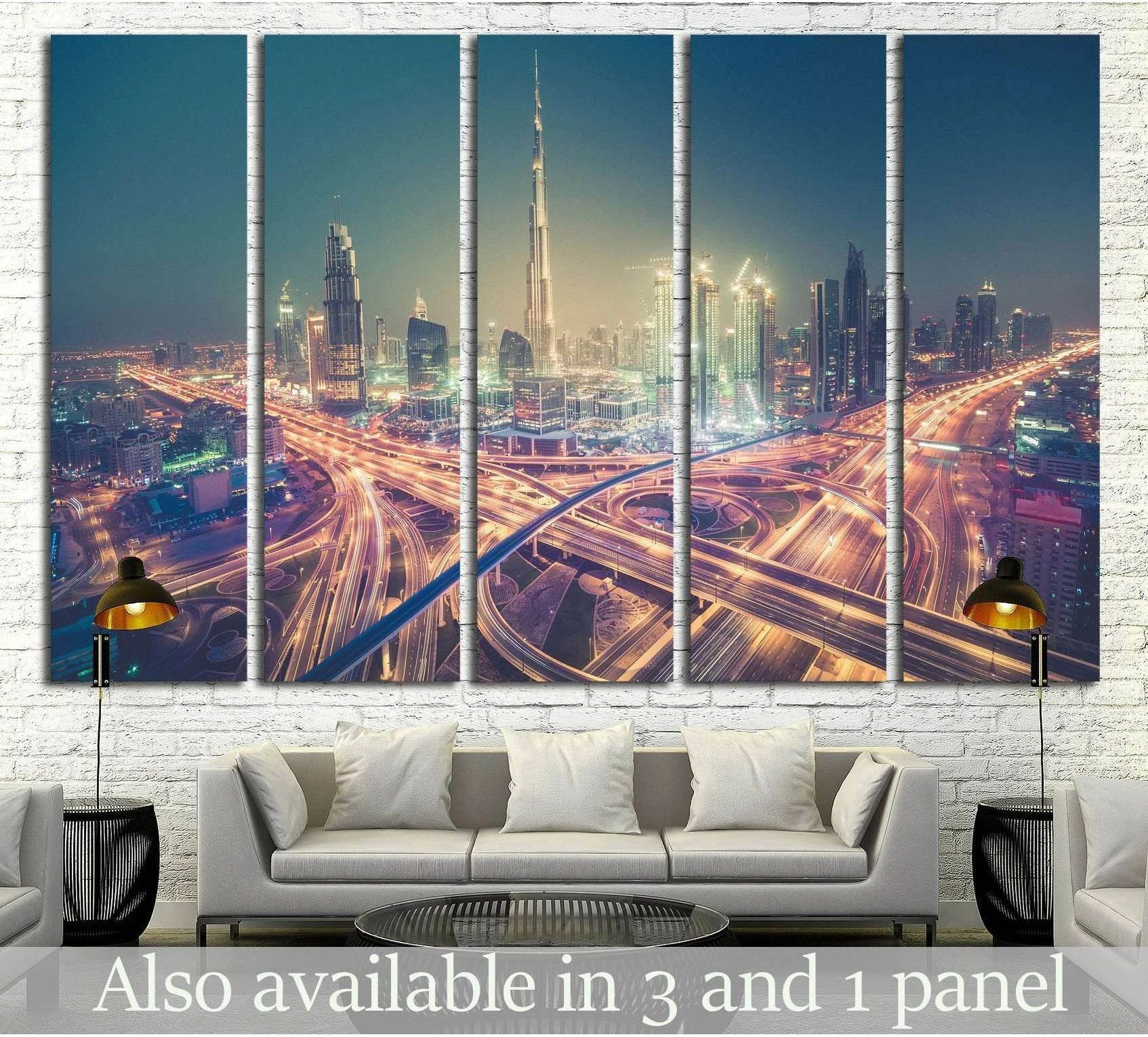Dubai skyline canvas print with Burj Khalifa and glowing highway light trails above a sofa in a modern living room