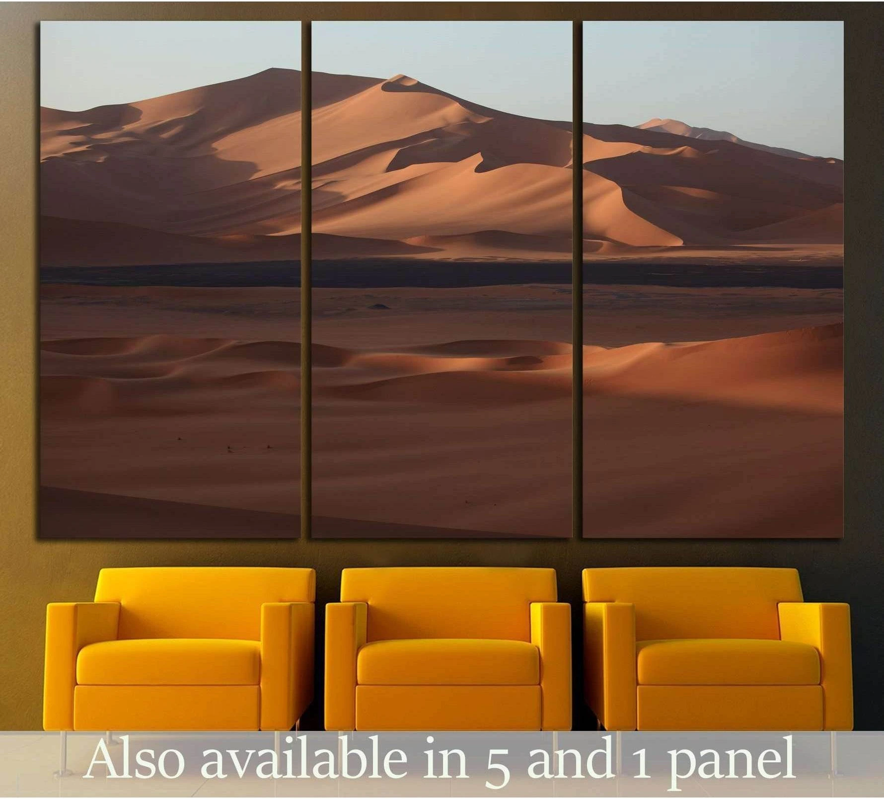 Triptych Sahara dunes canvas print hung above three mustard chairs in a modern waiting area