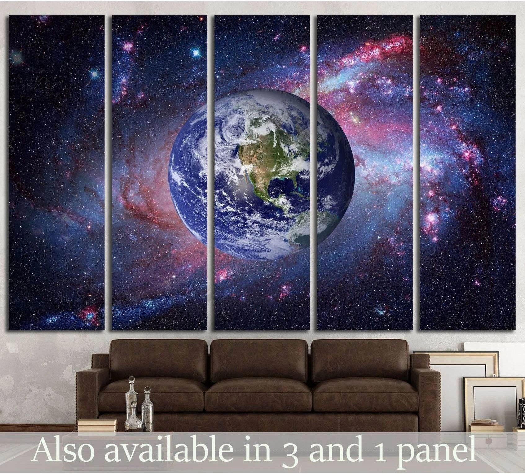 Earth canvas print centered in a blue and purple spiral galaxy above a sofa in a modern living room