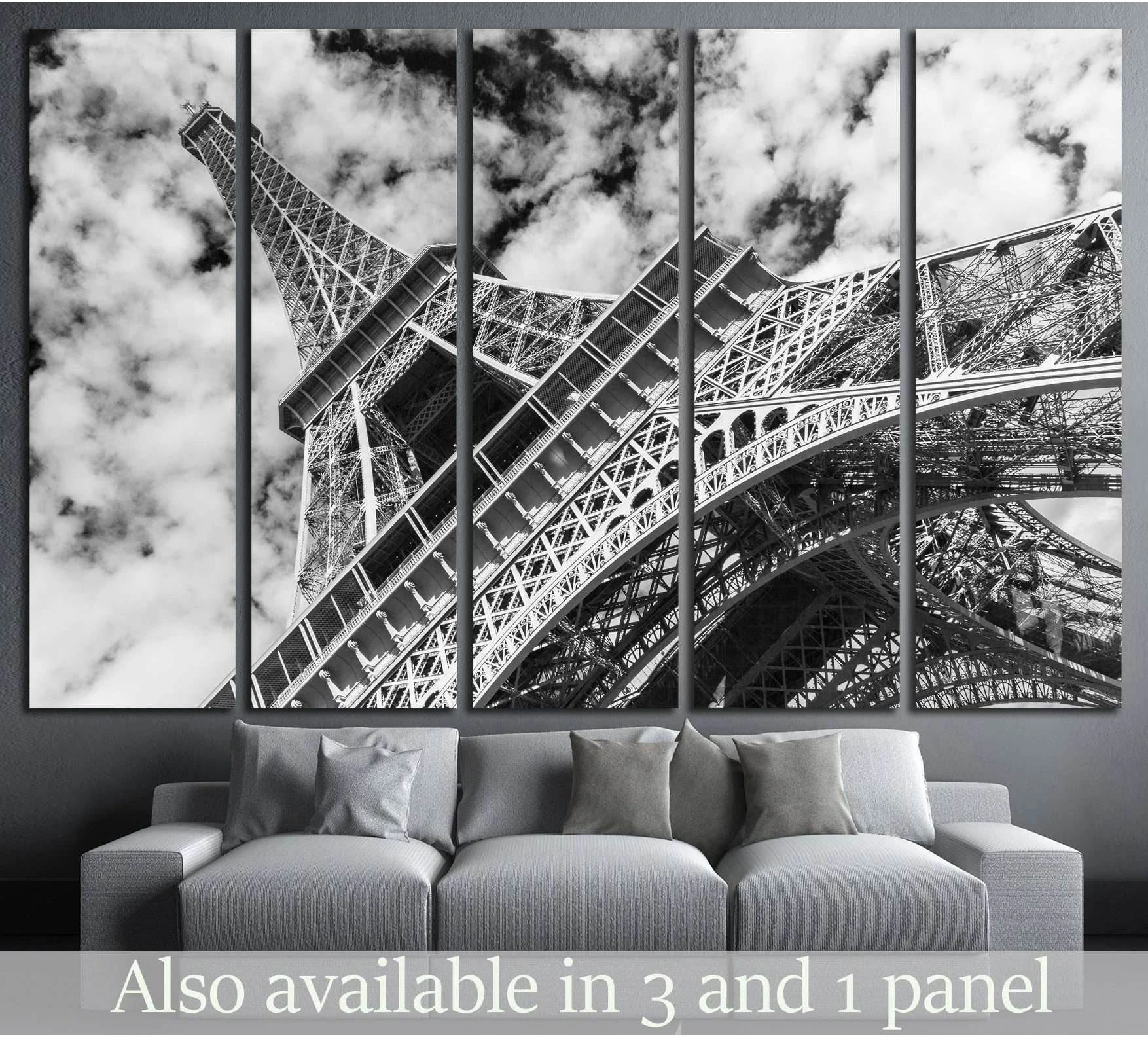 Black and white Eiffel Tower canvas print in five panels above a sofa in a modern living room