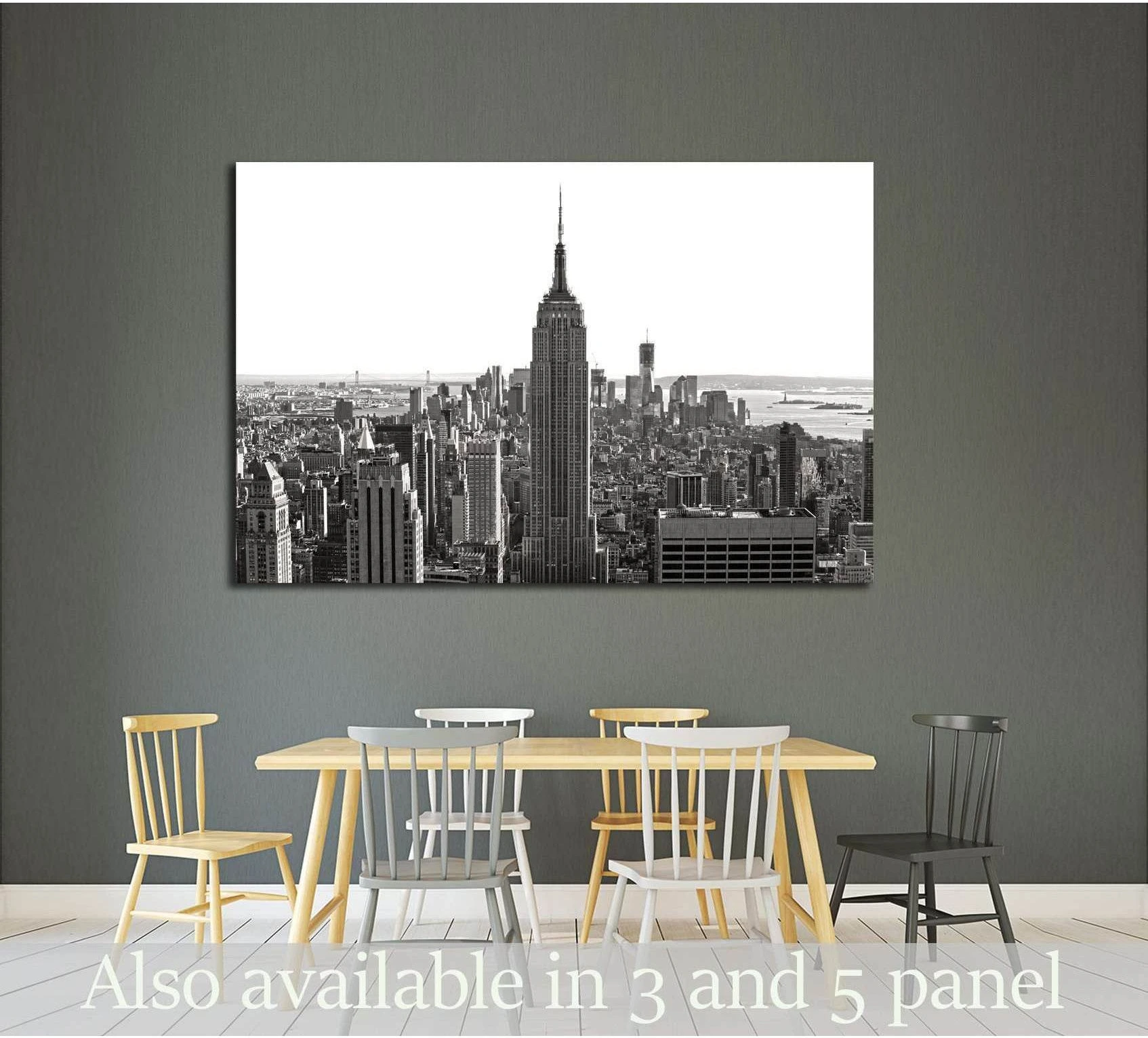 Black and white Empire State Building canvas print above a dining table in a modern room