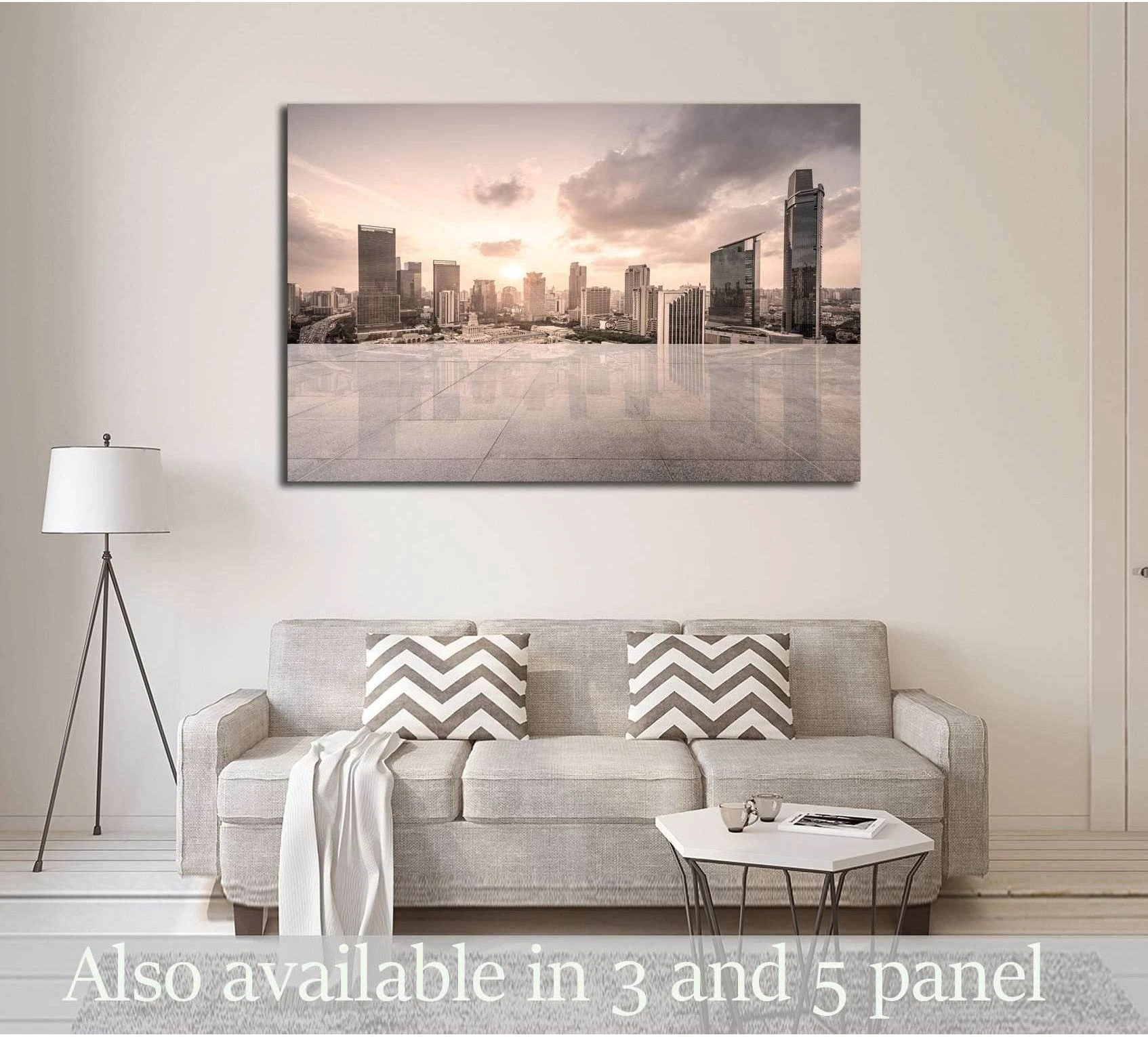 Modern skyline canvas print with glass towers and open tiled plaza above sofa in neutral living room