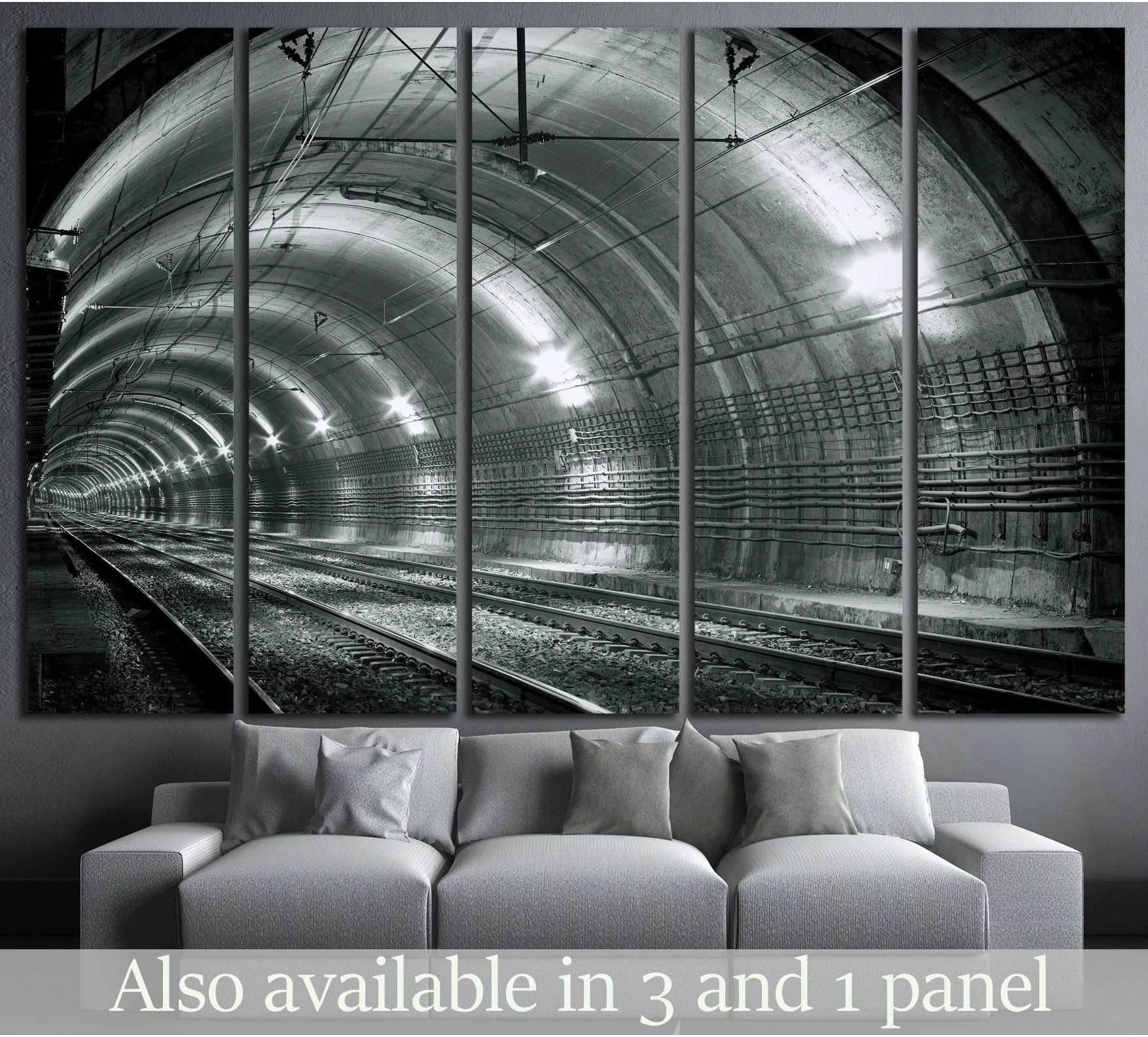 Black and white subway tunnel canvas print displayed above sofa in a modern living room