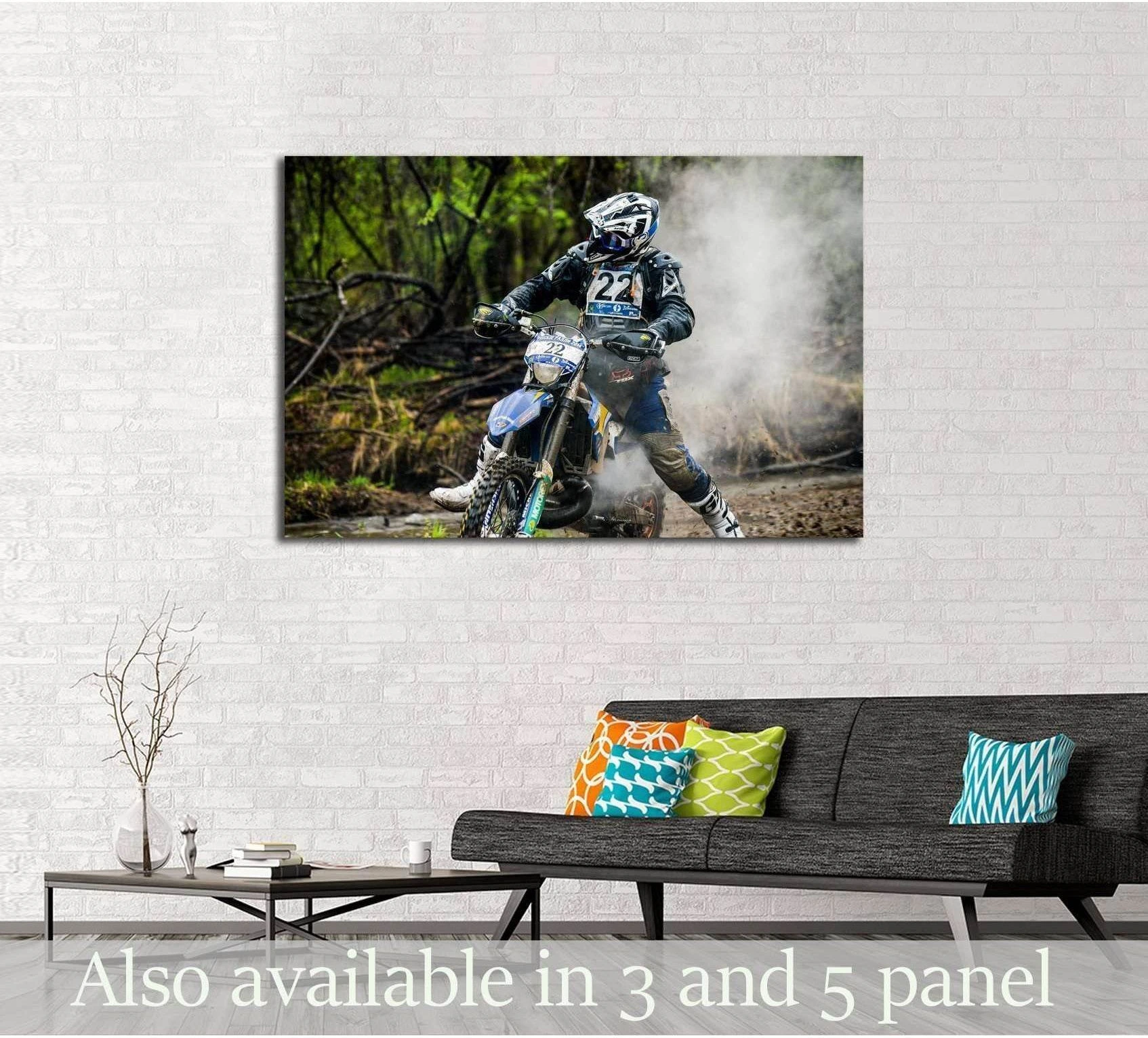 Enduro rider canvas print kicking up dust on a forest trail above sofa in a modern living room