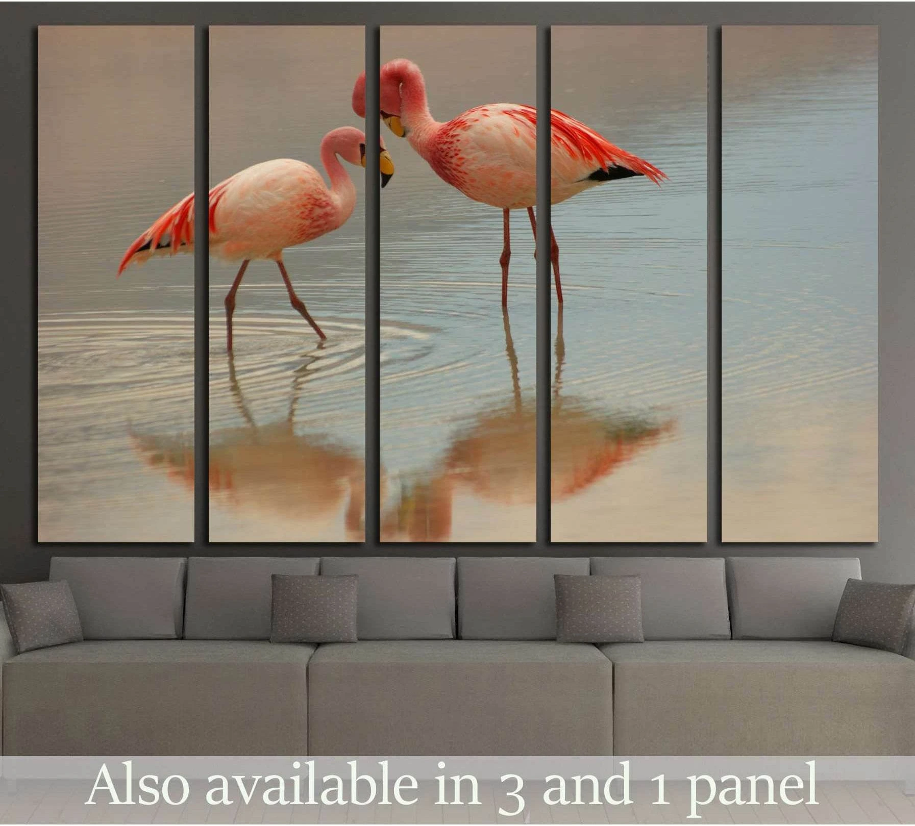Two pink flamingos wading in reflective water canvas print above sofa in a neutral living room
