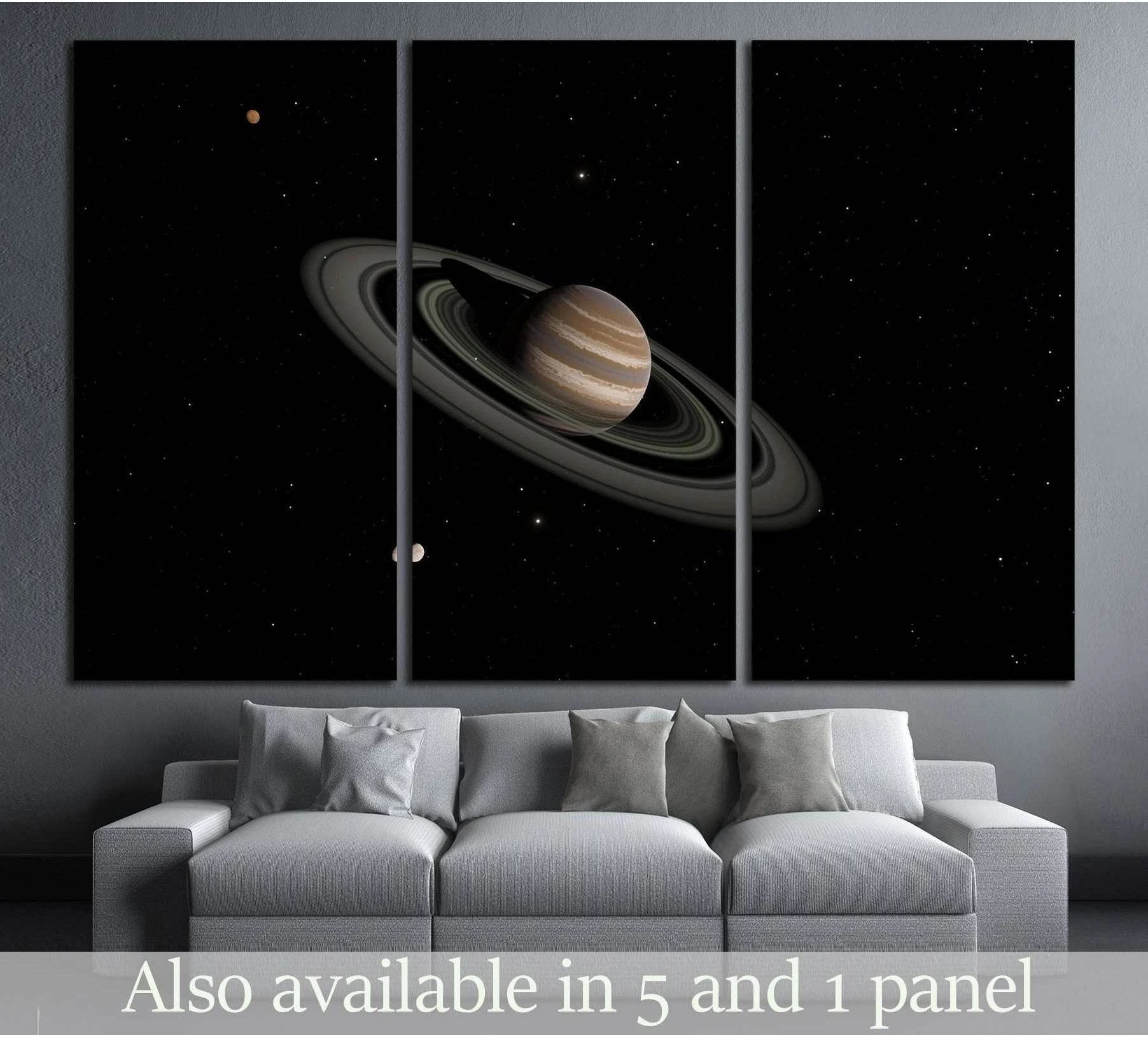 Saturn canvas print with rings on a black star field displayed as triptych wall art above a sofa