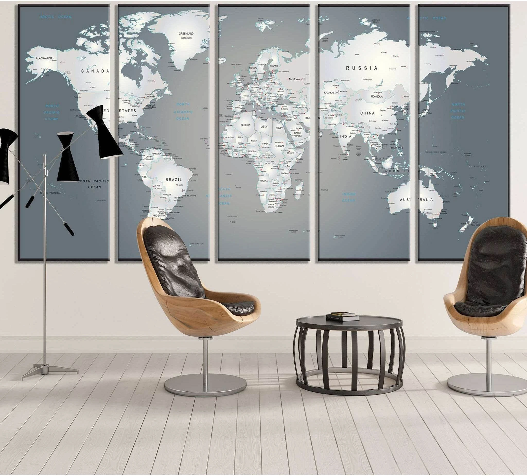Gray-blue multi-panel world map canvas print hung in a modern office-style living room
