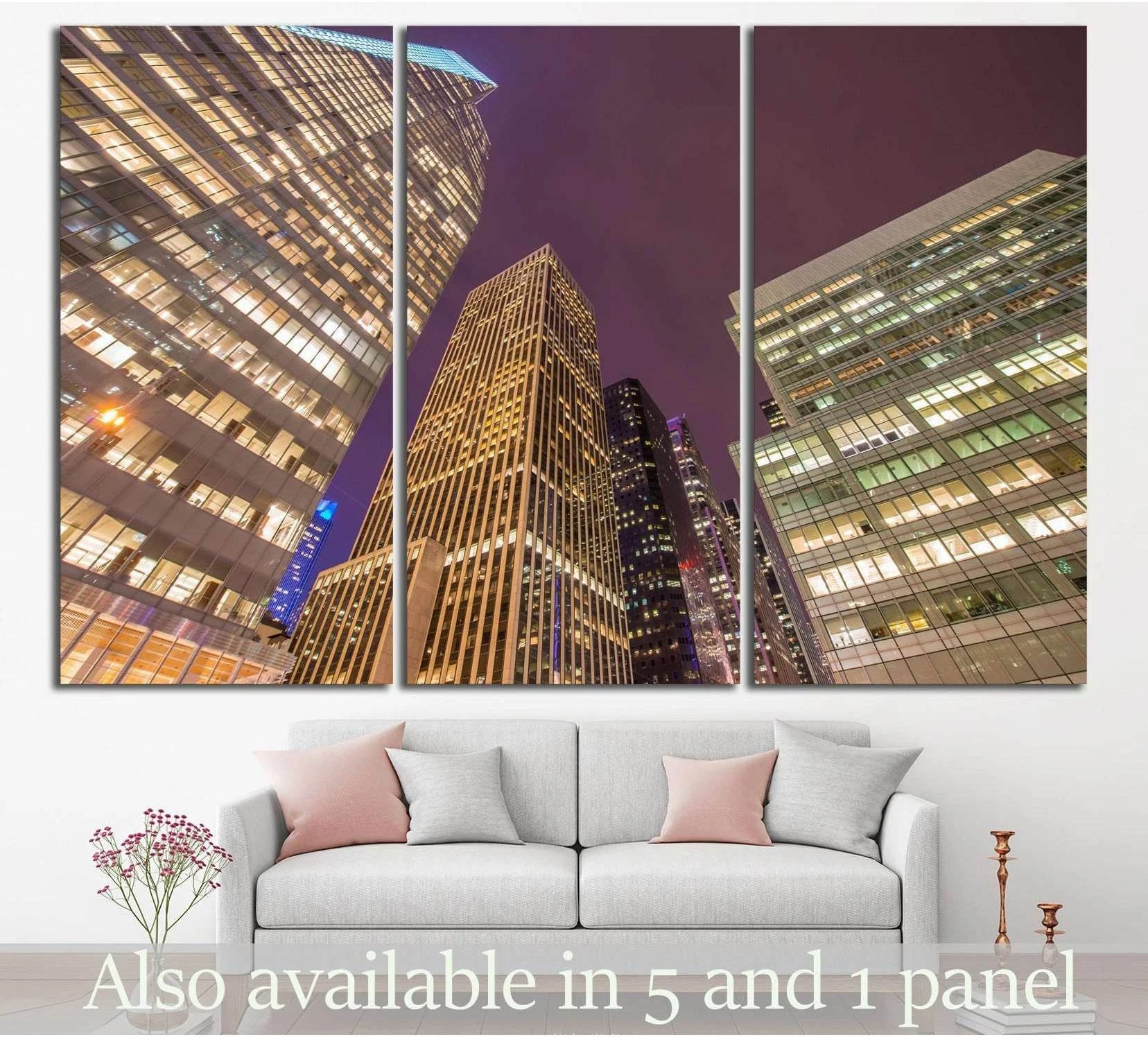 NYC skyscrapers canvas print in a three-panel night city view above a sofa
