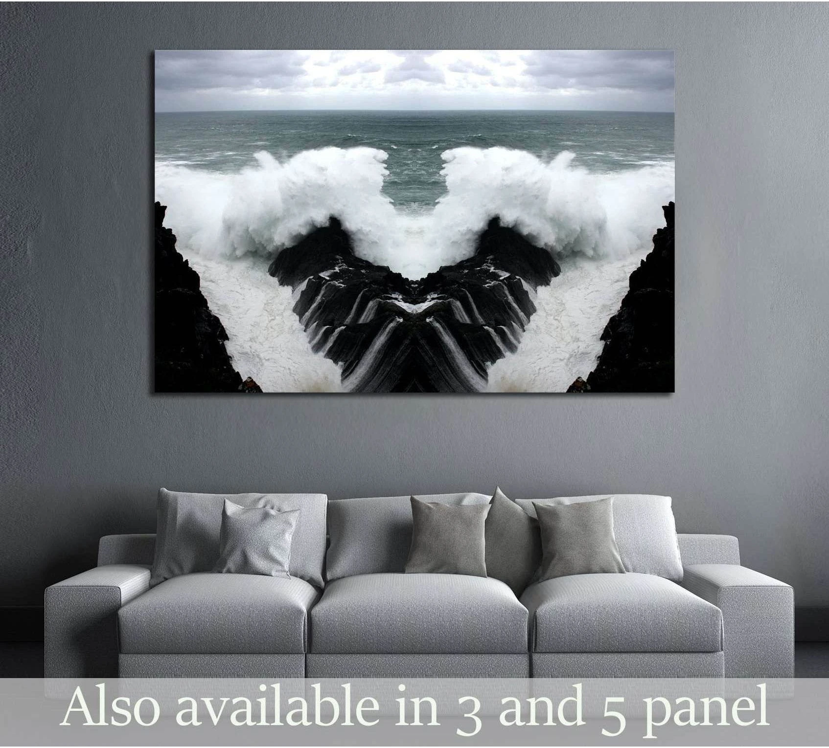 Mirrored wave canvas print with crashing surf between black cliffs above a sofa in a modern living room