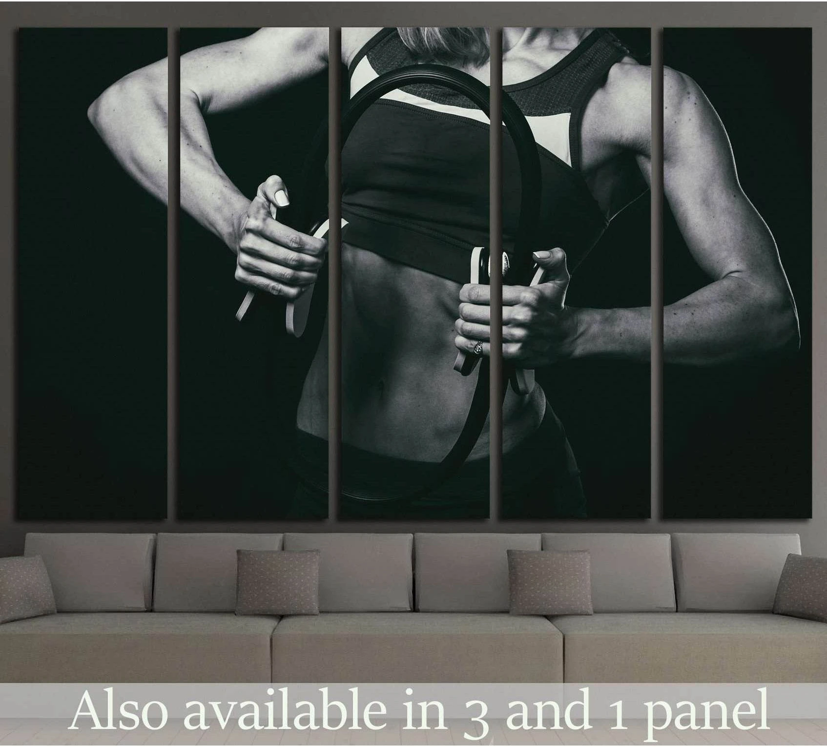 Black and white female fitness canvas print with athlete holding Pilates ring above a sofa