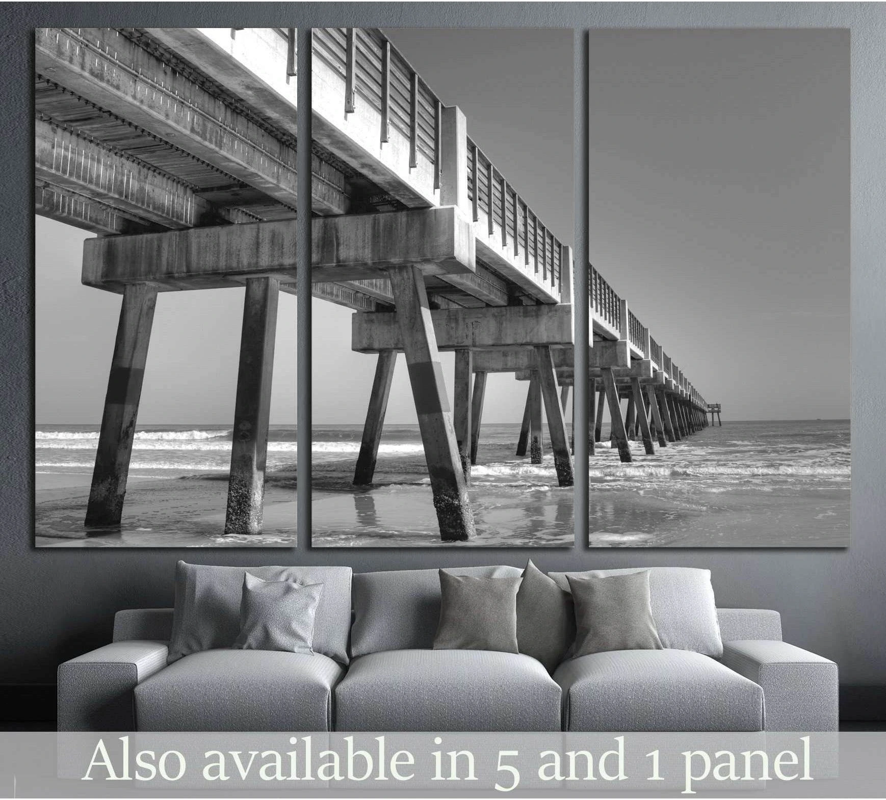 Black and white Jacksonville Beach pier canvas print displayed above a sofa in a modern living room