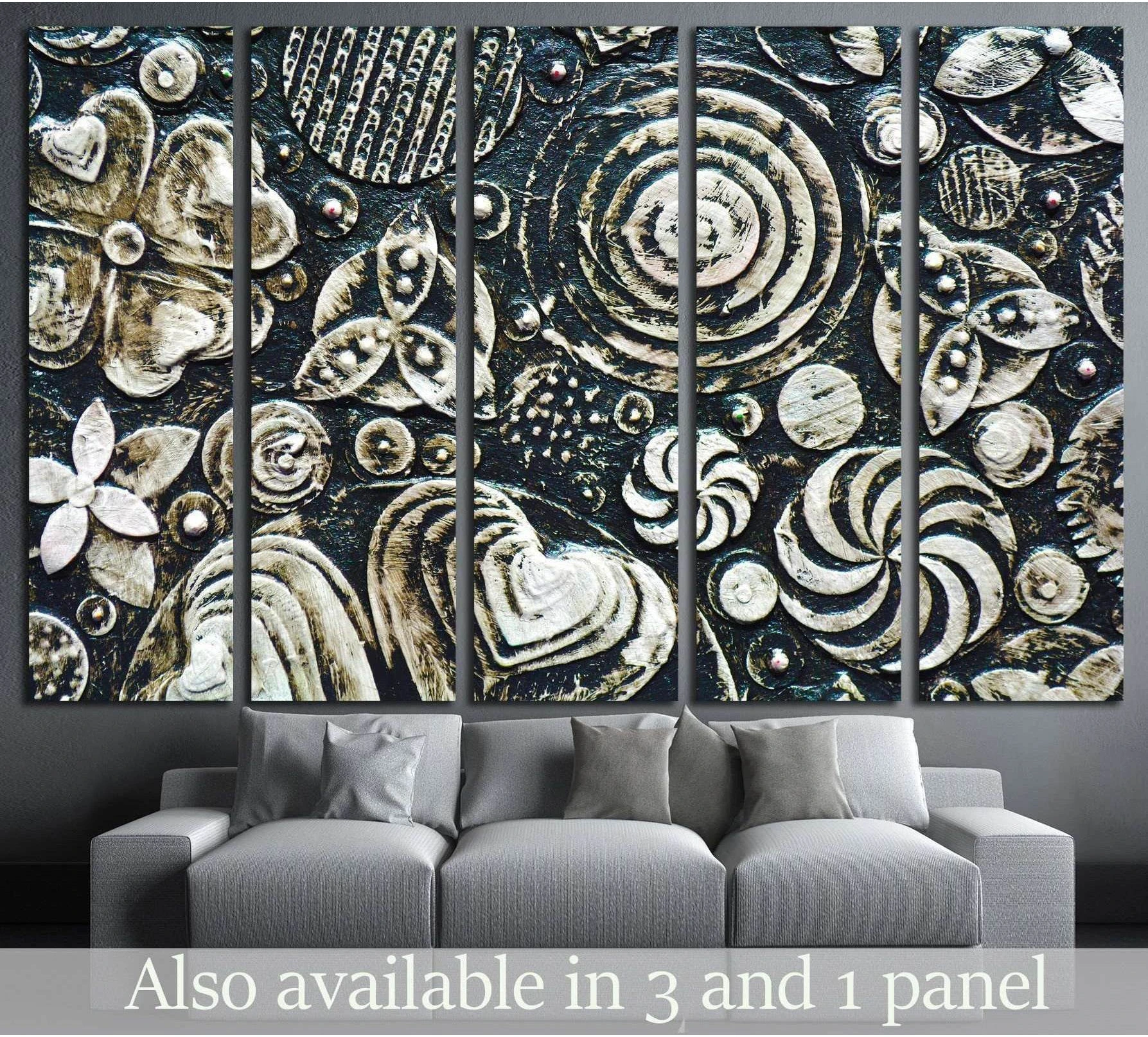Black and white floral abstract canvas print with textured grunge forms above a gray sofa