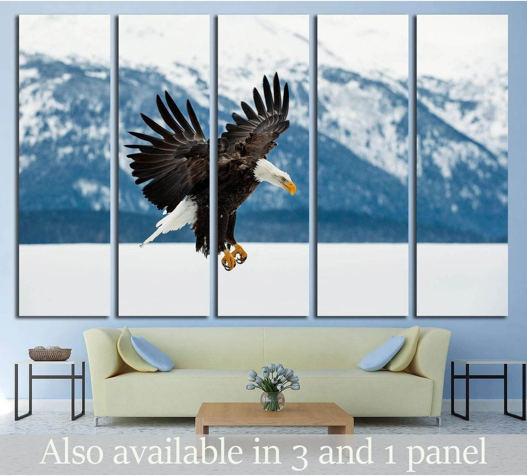 Bald eagle canvas print over snowy Alaska mountains, hung above a sofa in a modern living room