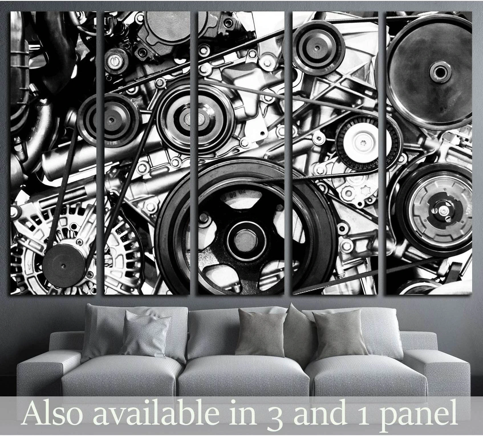 Black and white engine canvas print with exposed belts and pulleys, displayed above a grey sofa