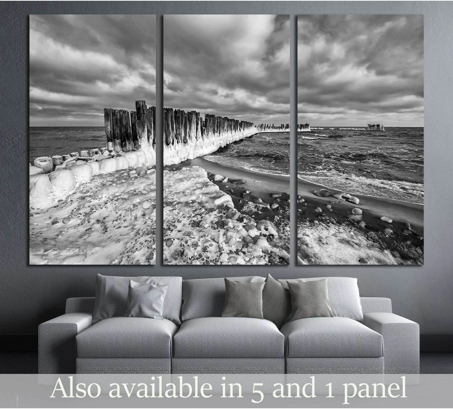 Frozen wooden breakwaters lineat Baltic Sea, Babie Doly, Poland showing sea water, shoreline and horizon depth.