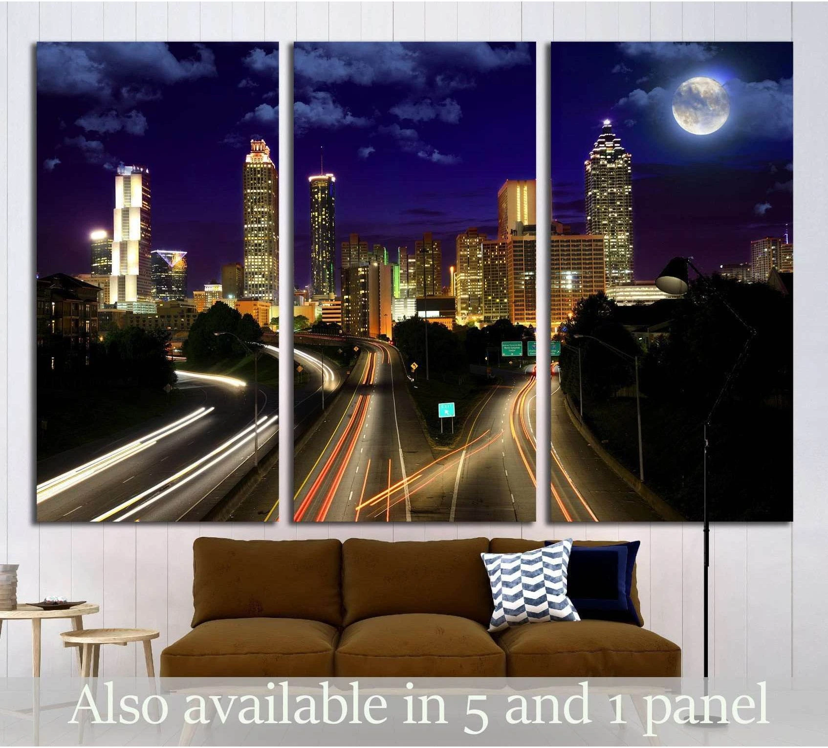 Atlanta skyline canvas print with full moon and highway light trails above a sofa in a modern living room