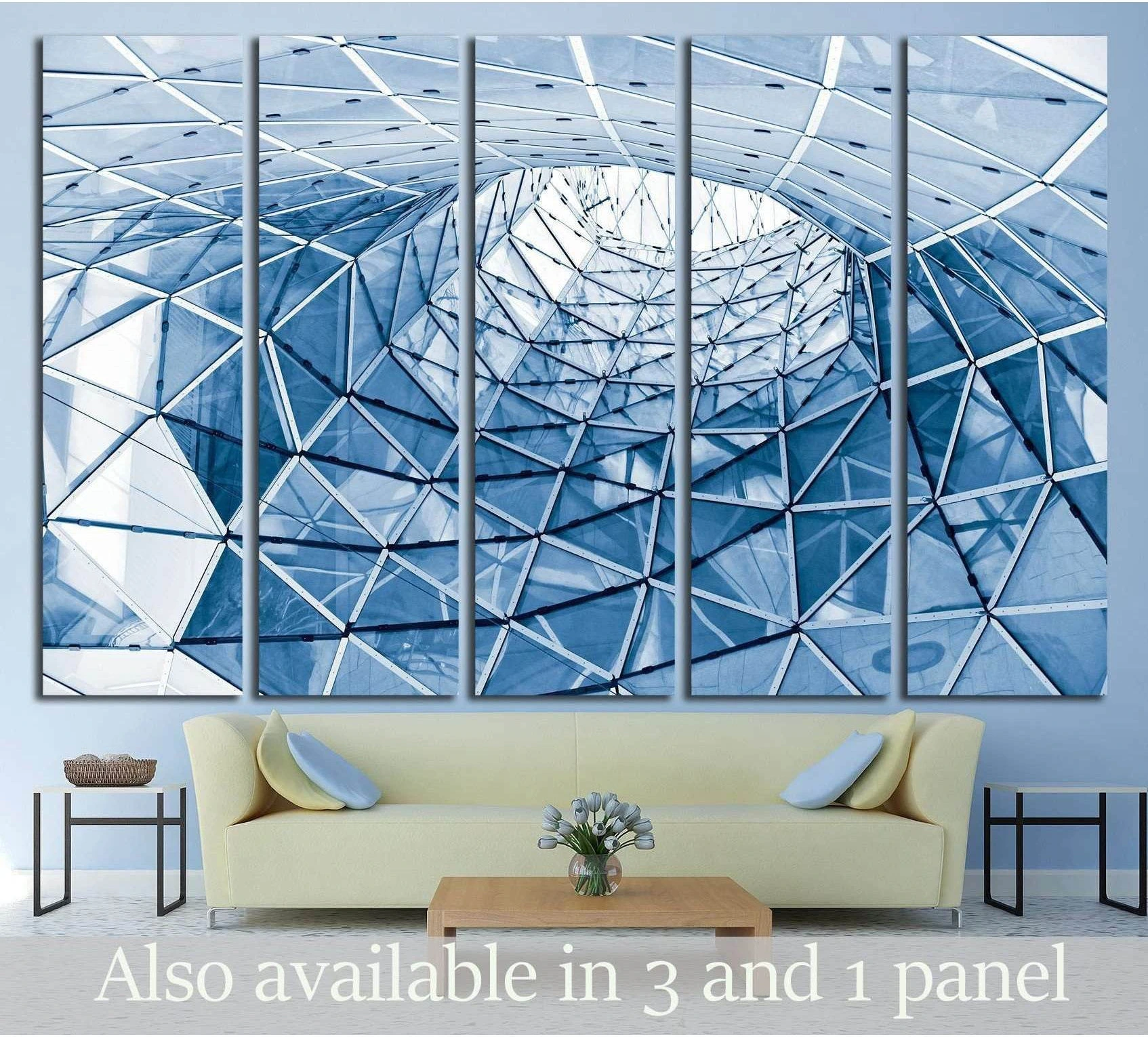 Blue geometric glass facade canvas print in five panels above sofa in a modern living room
