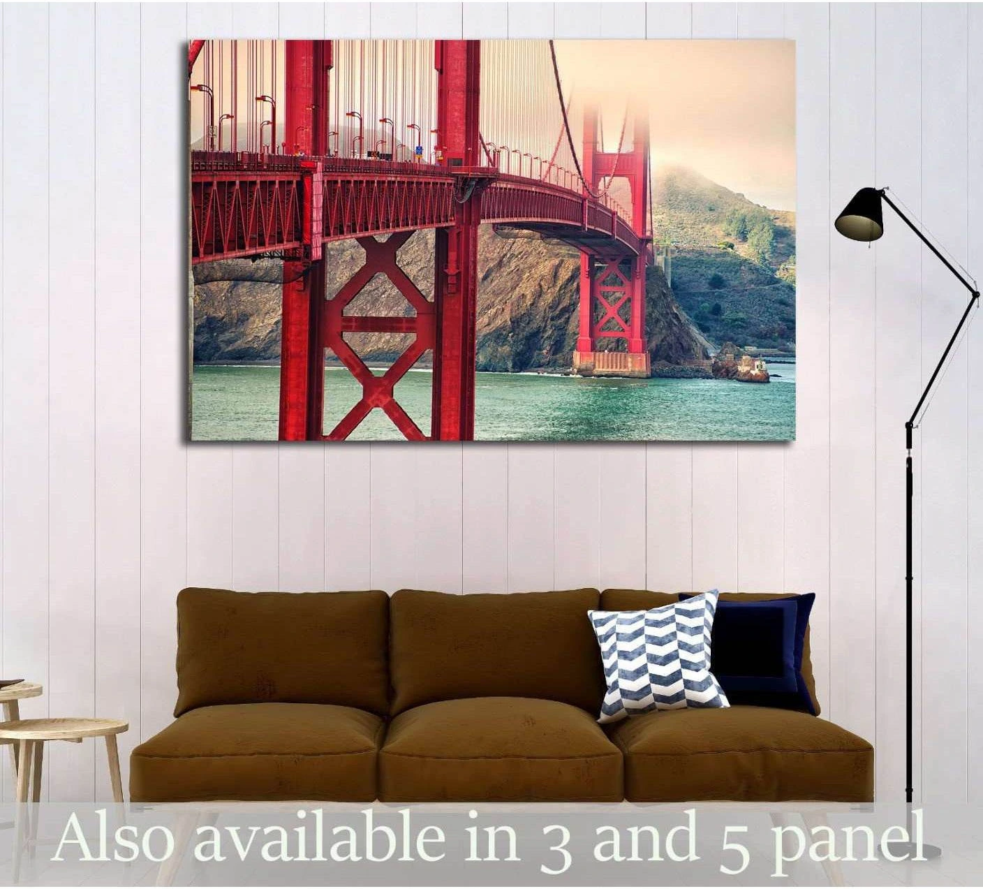 Golden Gate Bridge canvas print in red tones hung above a brown sofa in a modern living room