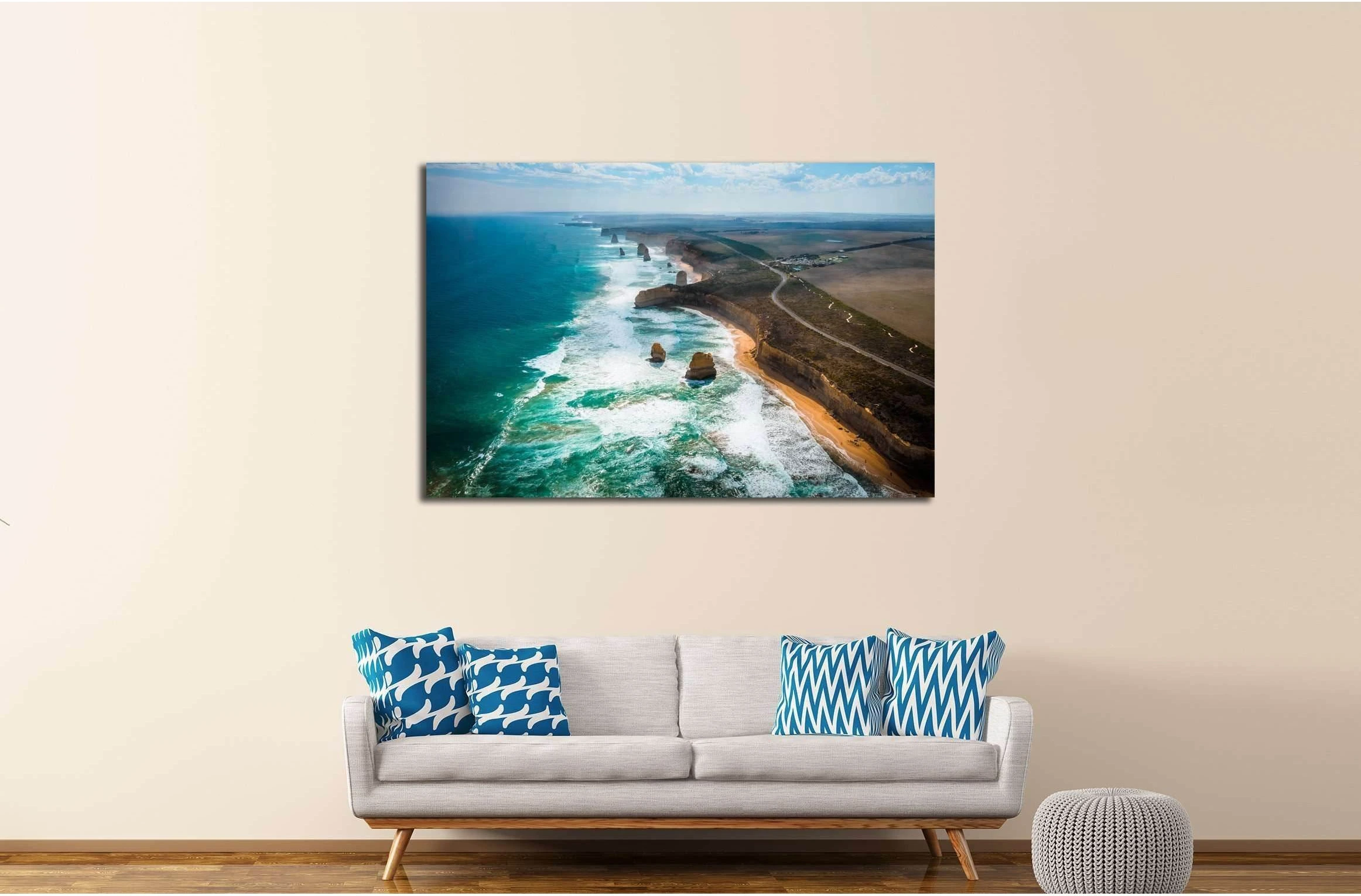 Aerial view of a turquoise ocean coastline with white surf, sea stacks and rugged cliffs detail view