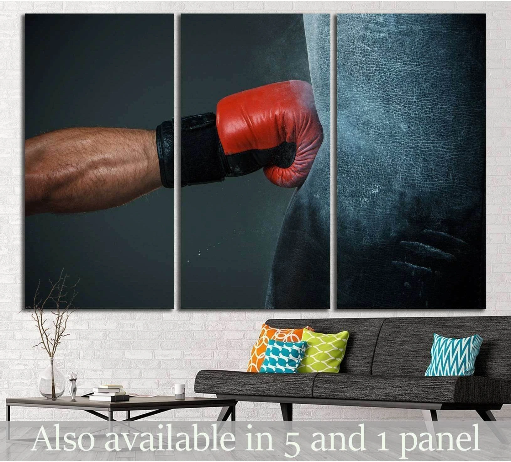 Red boxing glove striking a black heavy bag triptych canvas print above a sofa