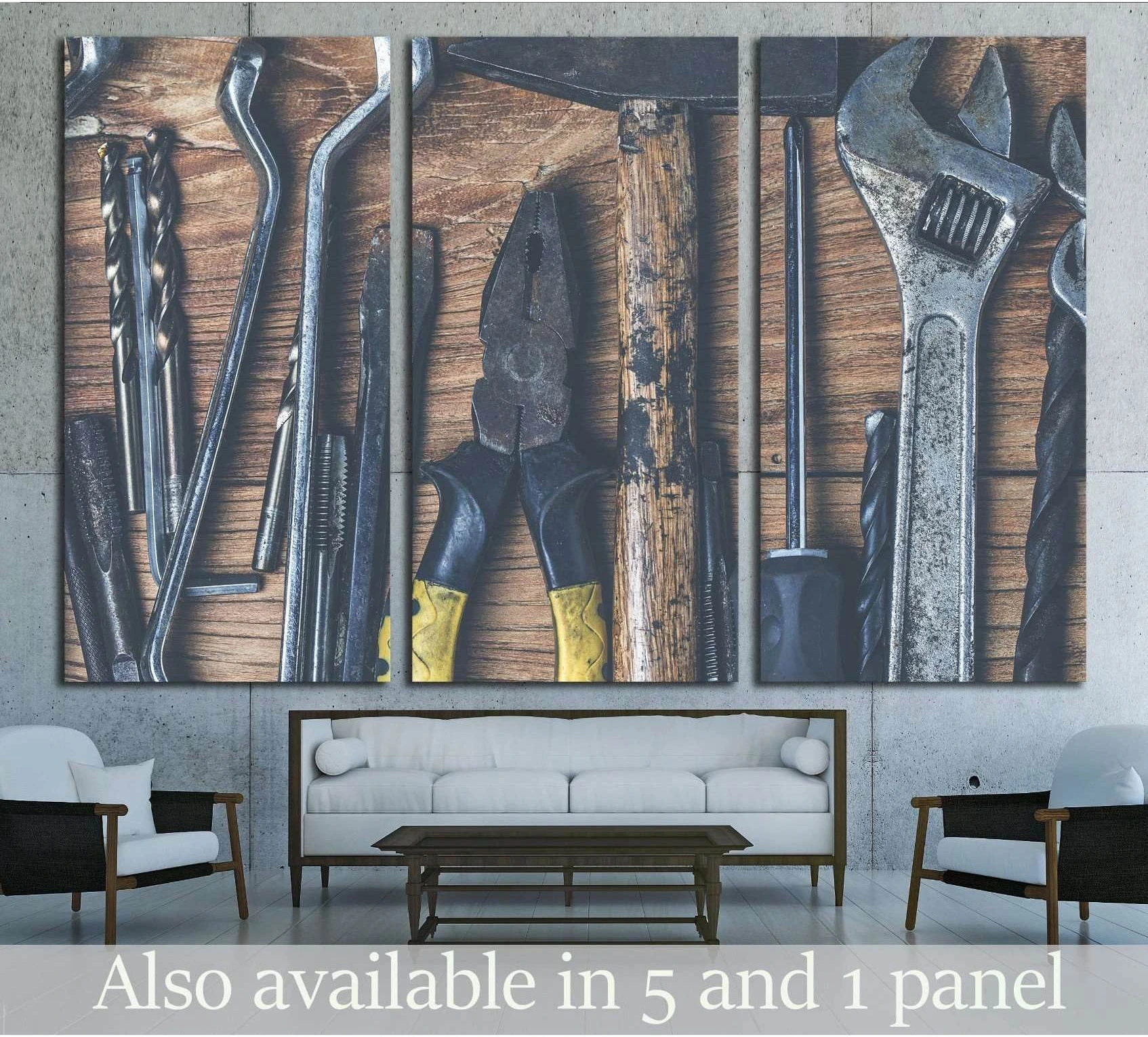 Triptych vintage tools canvas print hung above sofa in an industrial living room