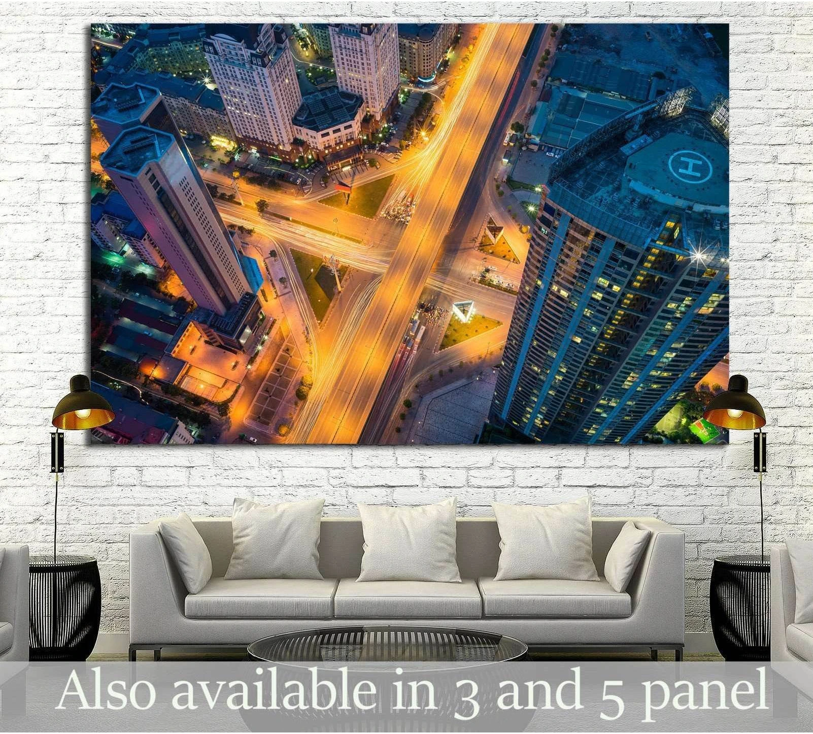 Aerial Hanoi cityscape canvas print with glowing crossroads above a sofa in a modern living room