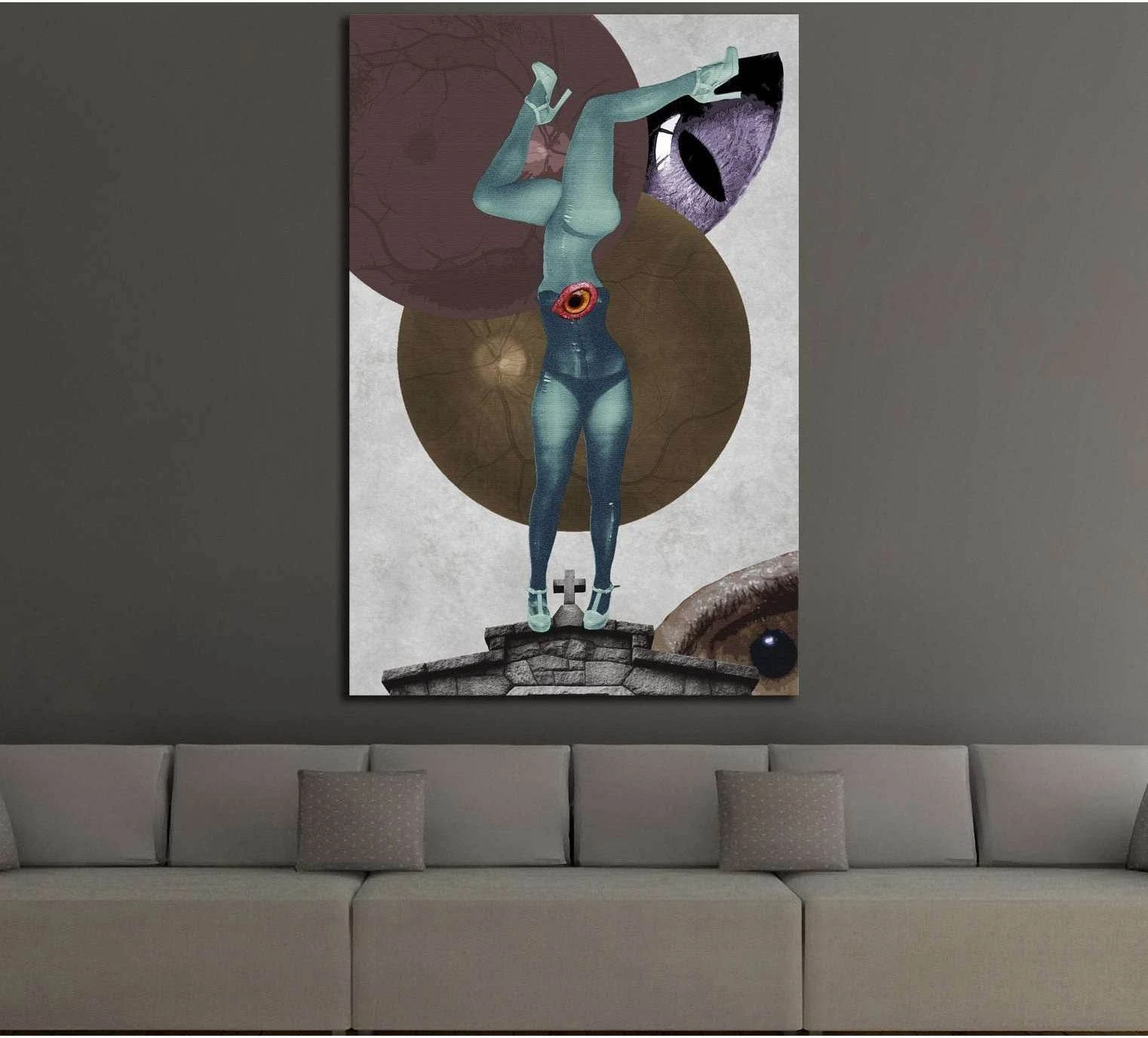 Surreal collage canvas print with upside-down teal figure and eye motif above a modern sofa