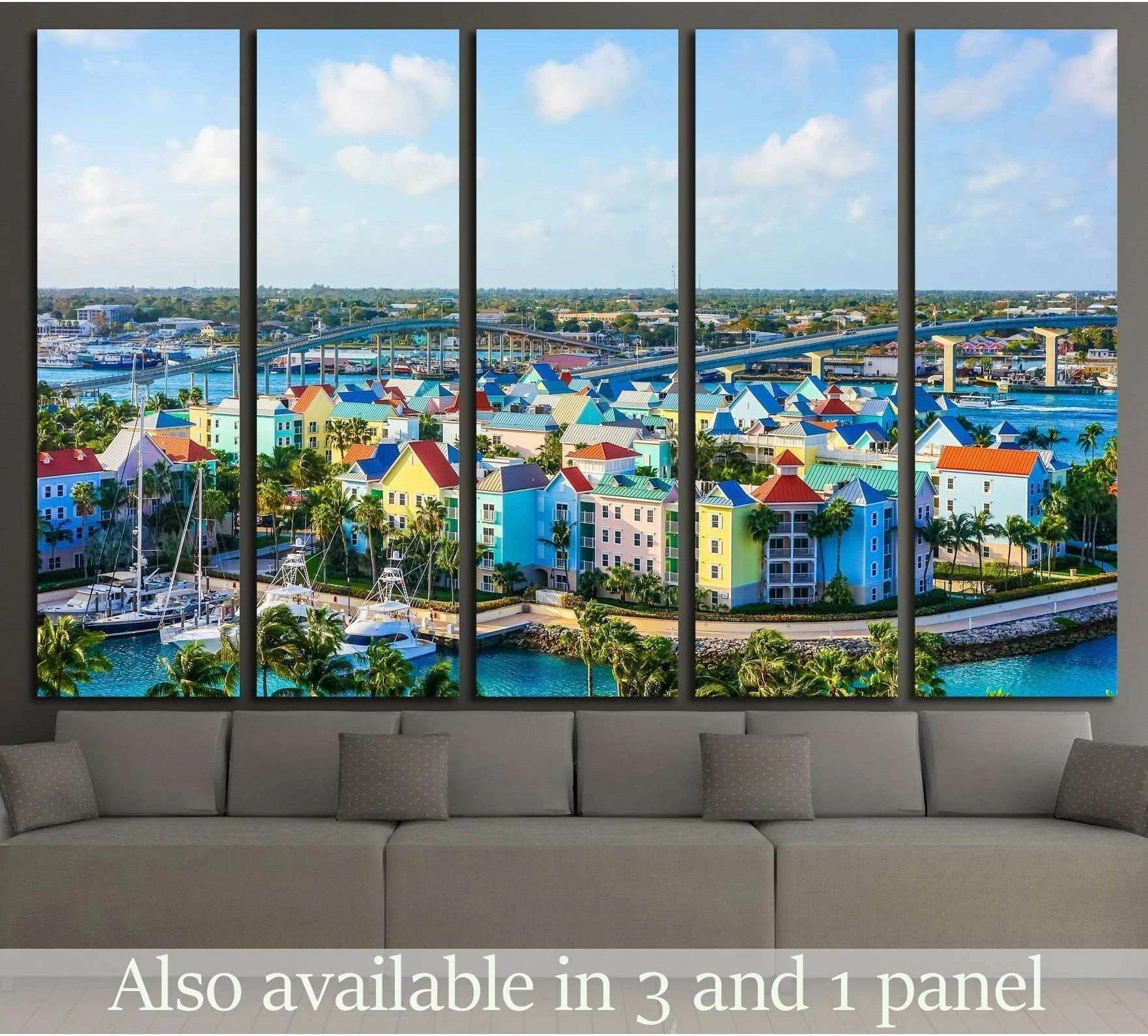 Nassau aerial canvas print with pastel waterfront buildings, marina boats, bridge, and turquoise water above a sofa