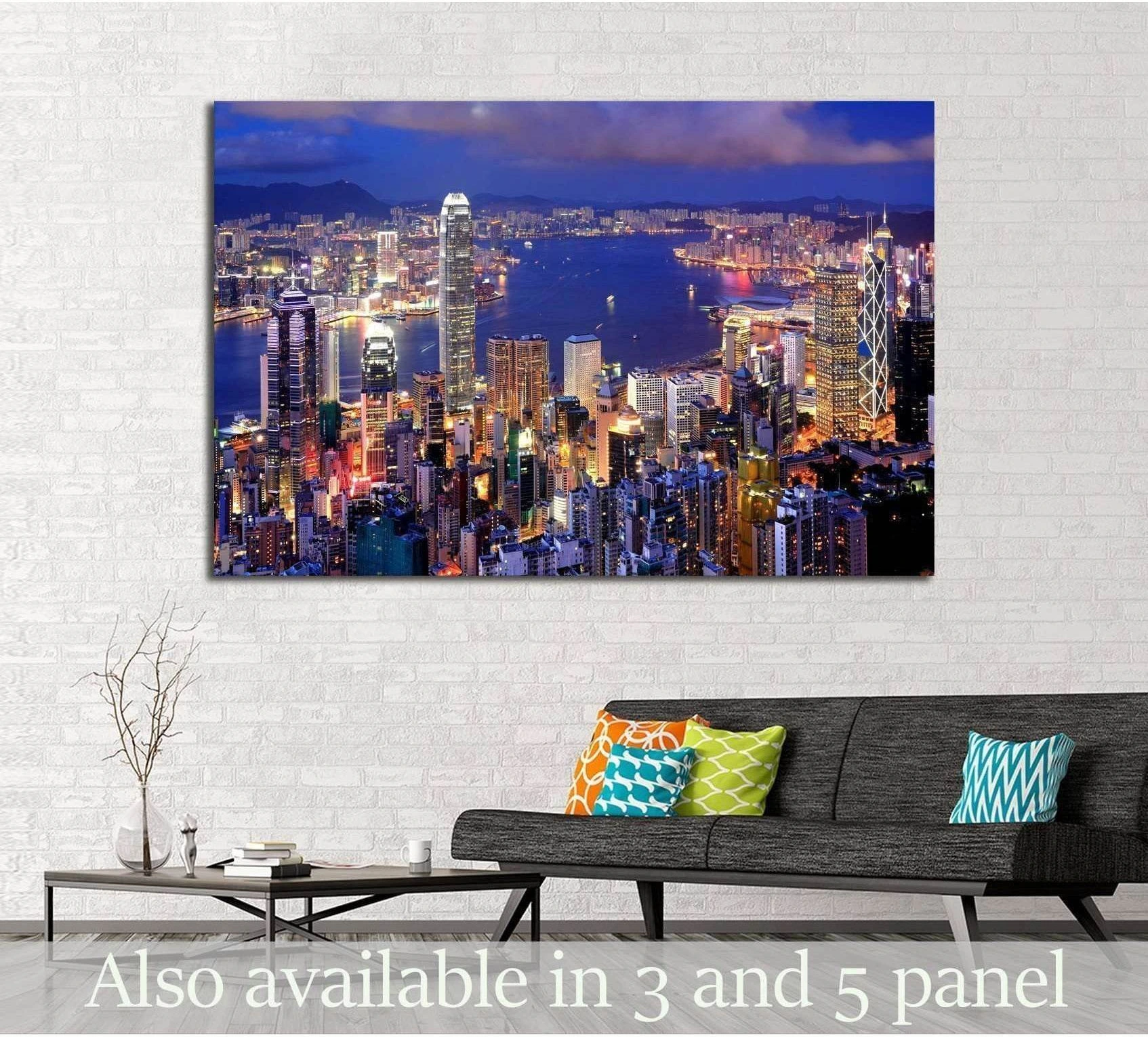 Hong Kong night skyline canvas print above sofa in modern living room with blue harbor lights
