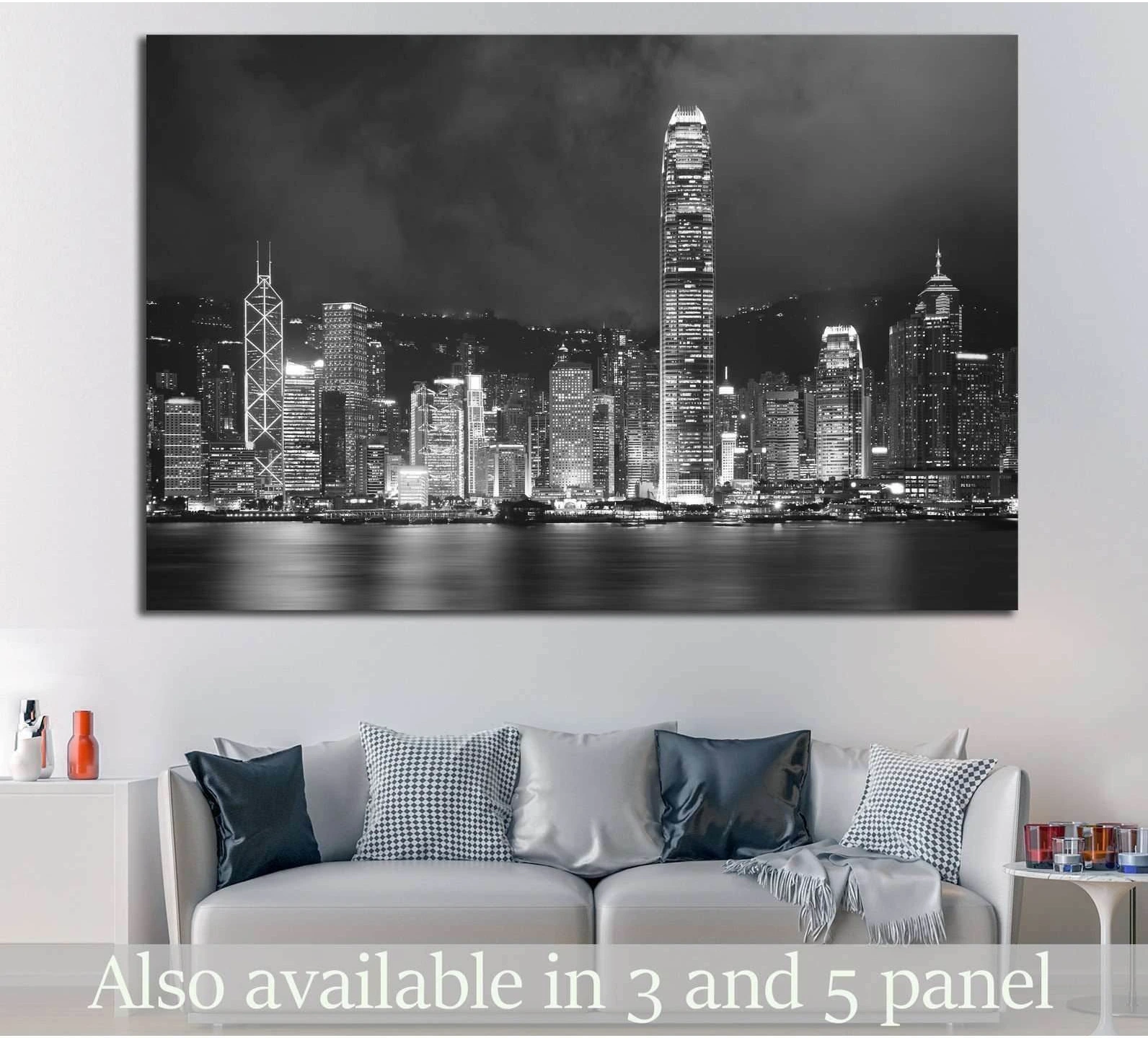 Black and white Hong Kong harbor skyline canvas print above a sofa in a modern living room