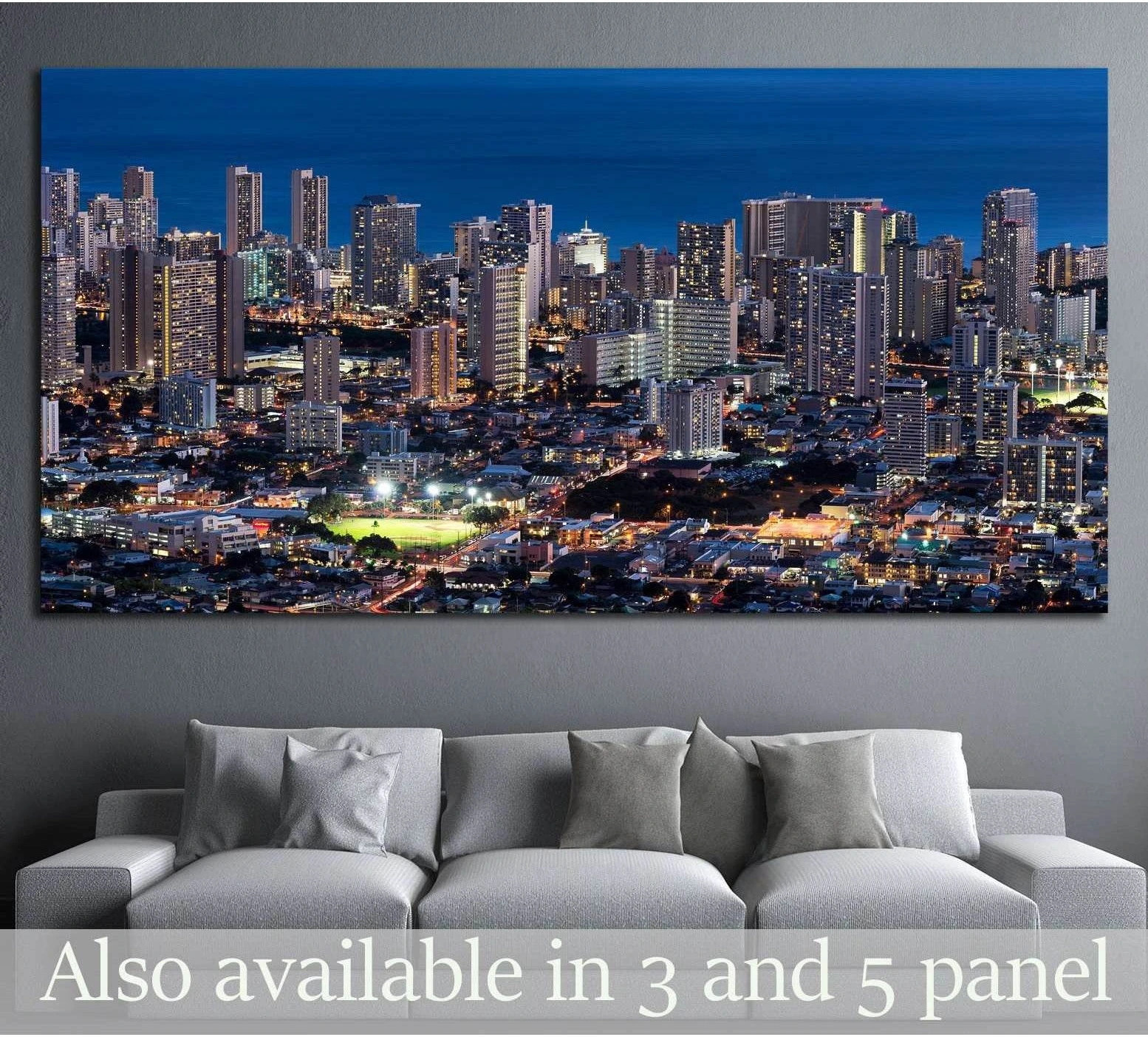 Honolulu skyline canvas print with illuminated high-rises above a sofa in a modern living room