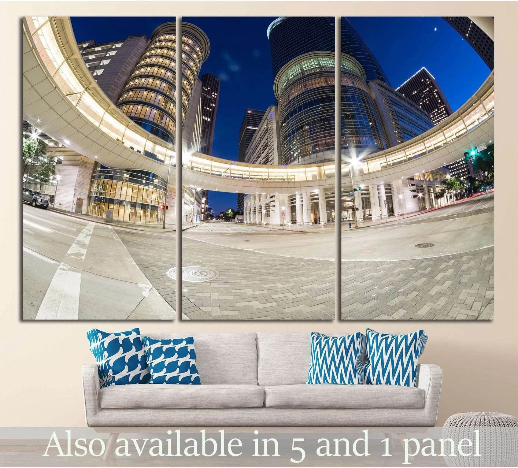 Houston skyline triptych canvas print with lit skyscrapers and curved skywalk above a sofa in a modern living room
