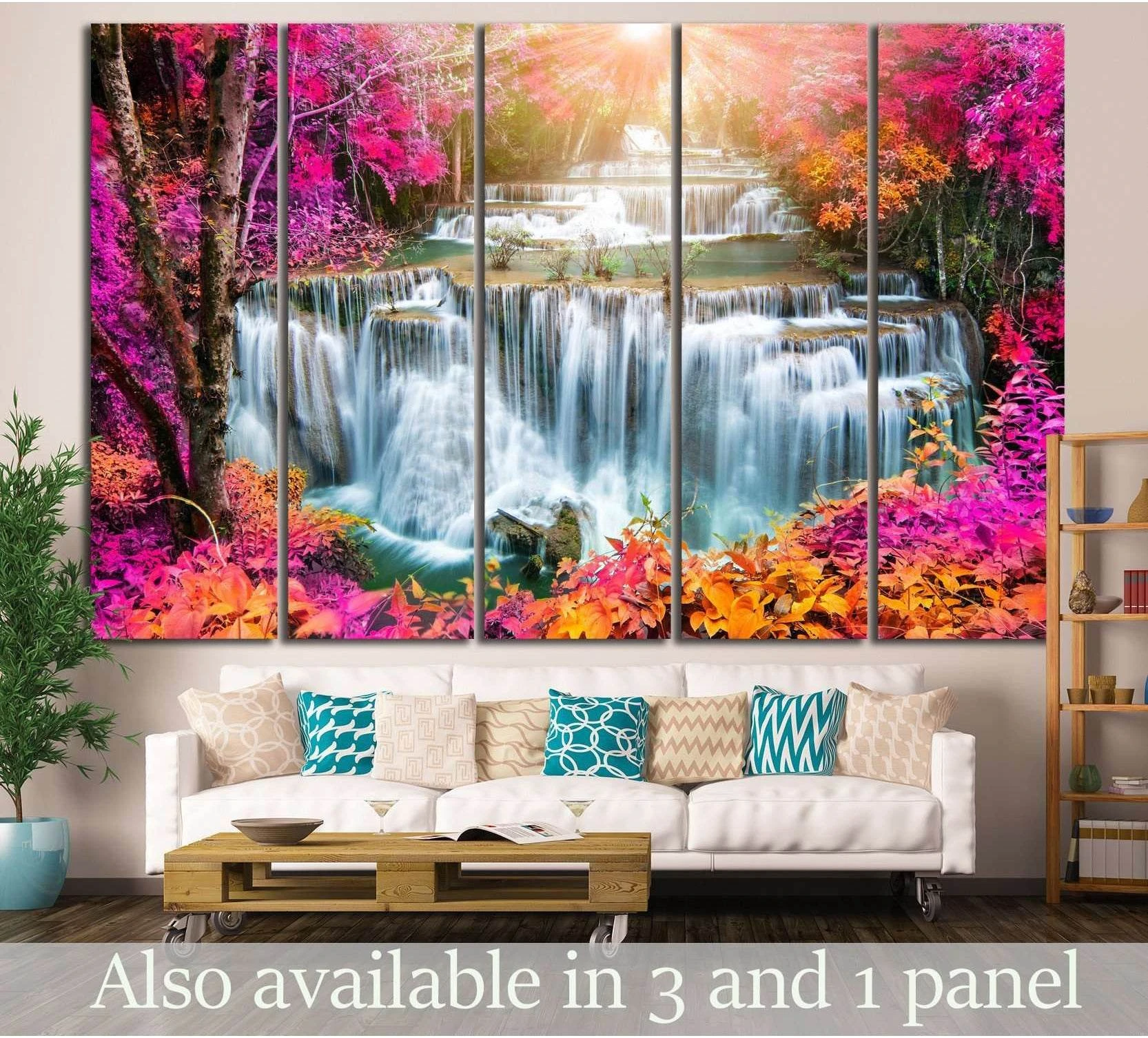 Huay Mae Kamin waterfall canvas print with pink tropical foliage above a sofa in a modern living room
