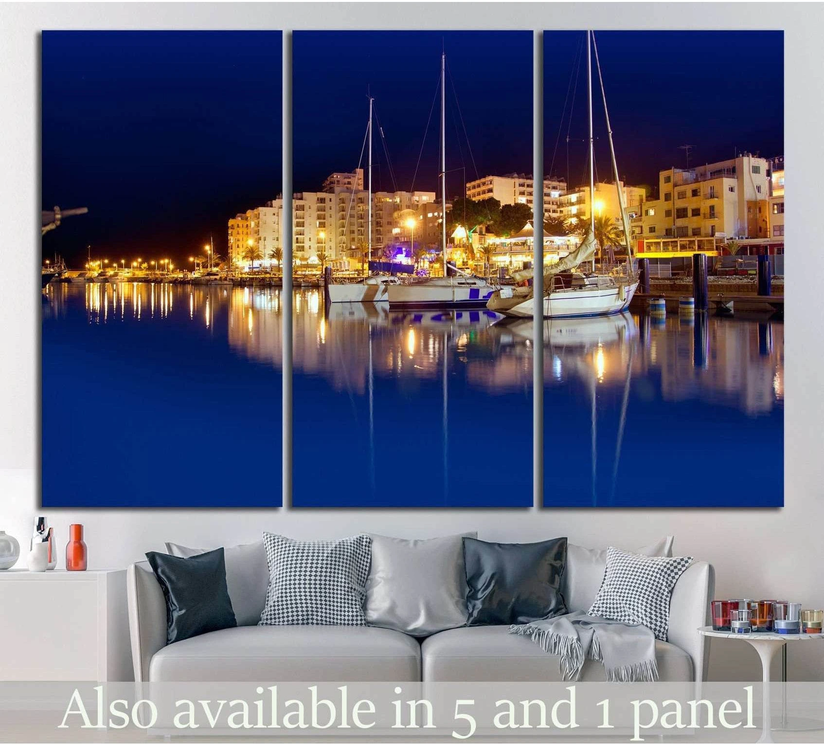 Ibiza harbor night canvas print with sailboats and glowing marina reflections above a sofa