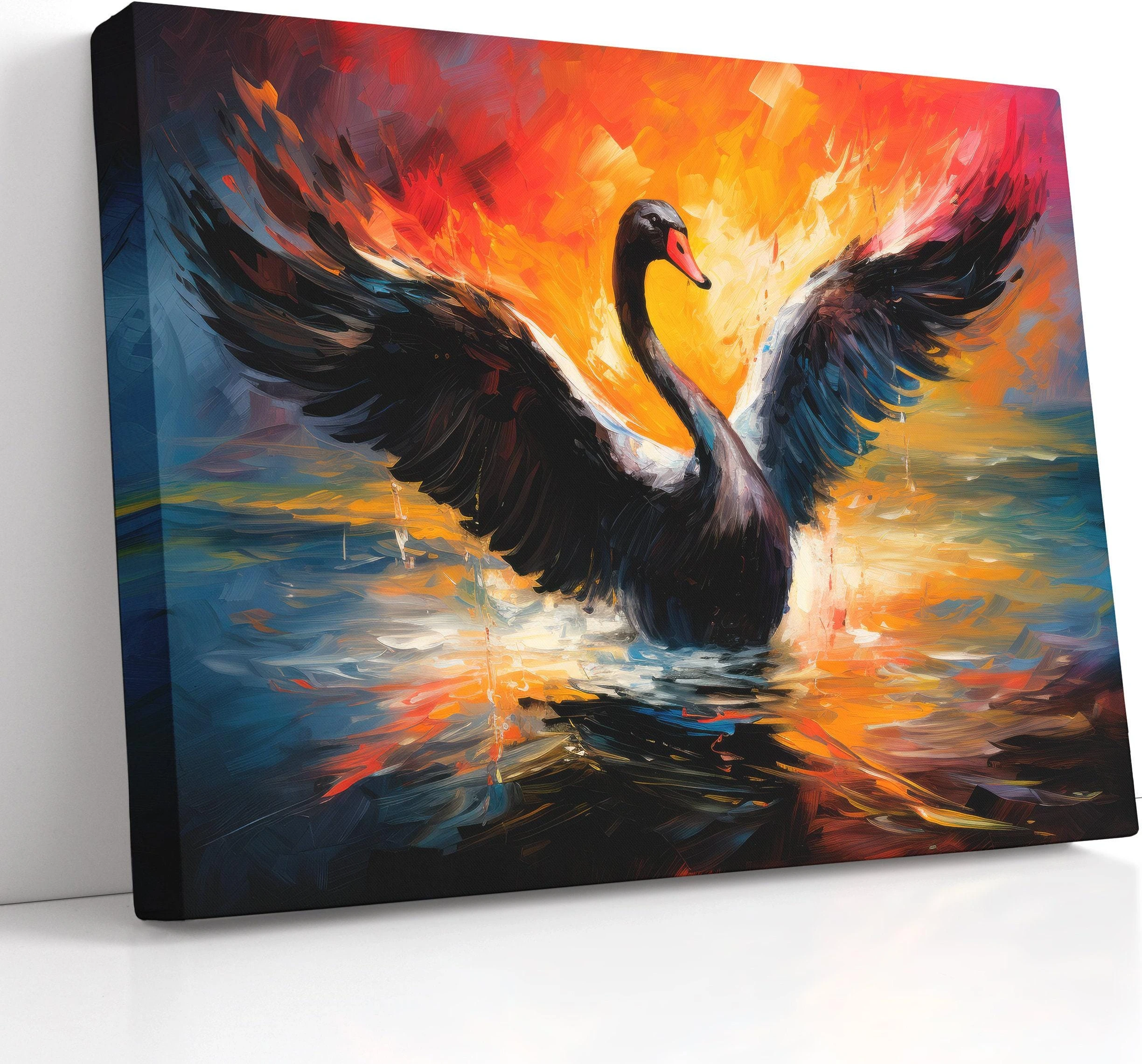 Black swan with wings spread over choppy blue water and fiery orange sunset light