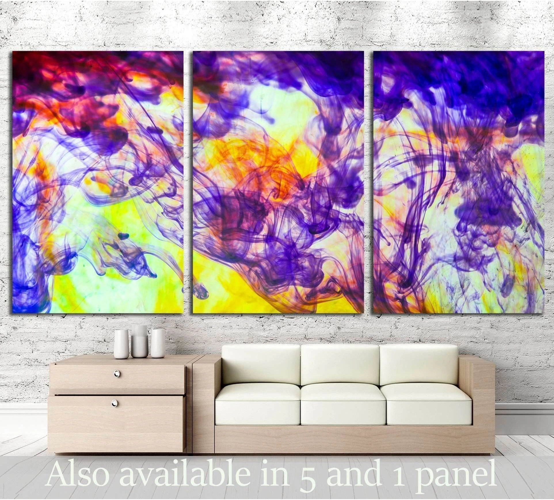 Triptych abstract ink swirl canvas print in purple, yellow, and orange above a sofa