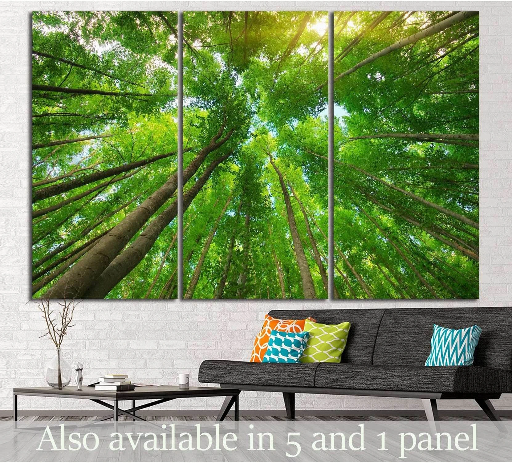 Forest canopy canvas print with tall green trees viewed from below above a modern sofa