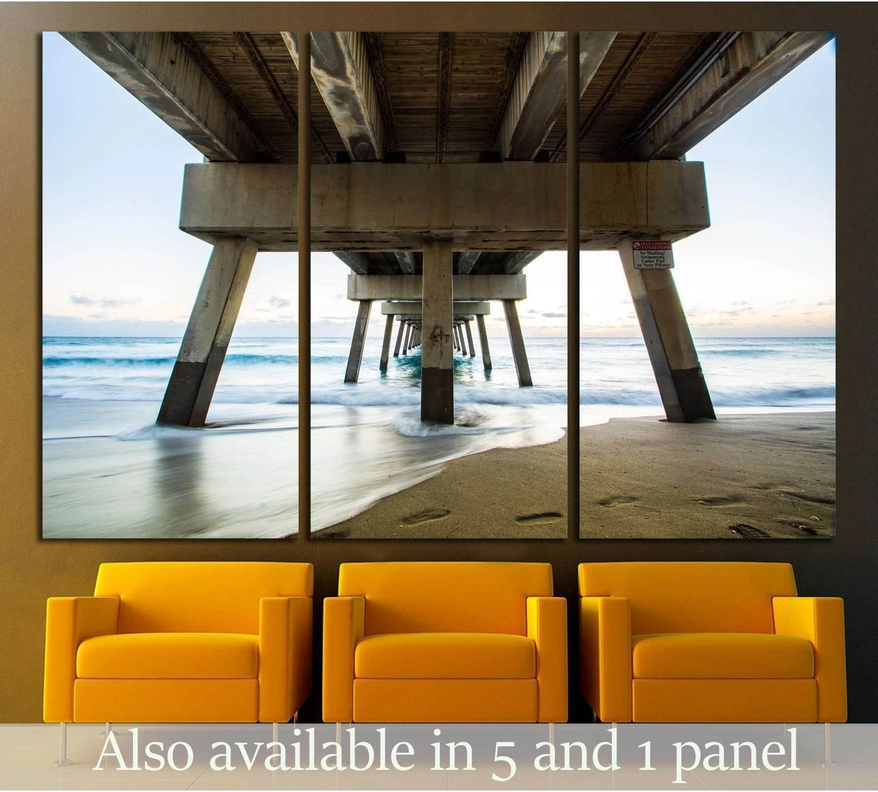 Juno Beach Pier sunrise canvas print hung above chairs with ocean waves and sandy shore