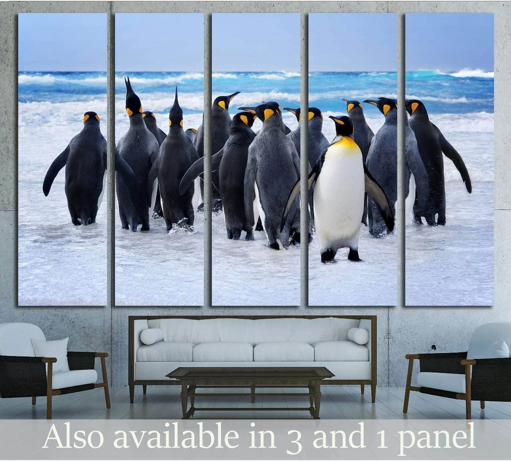Five-panel king penguin canvas print above sofa with penguins walking through shallow surf