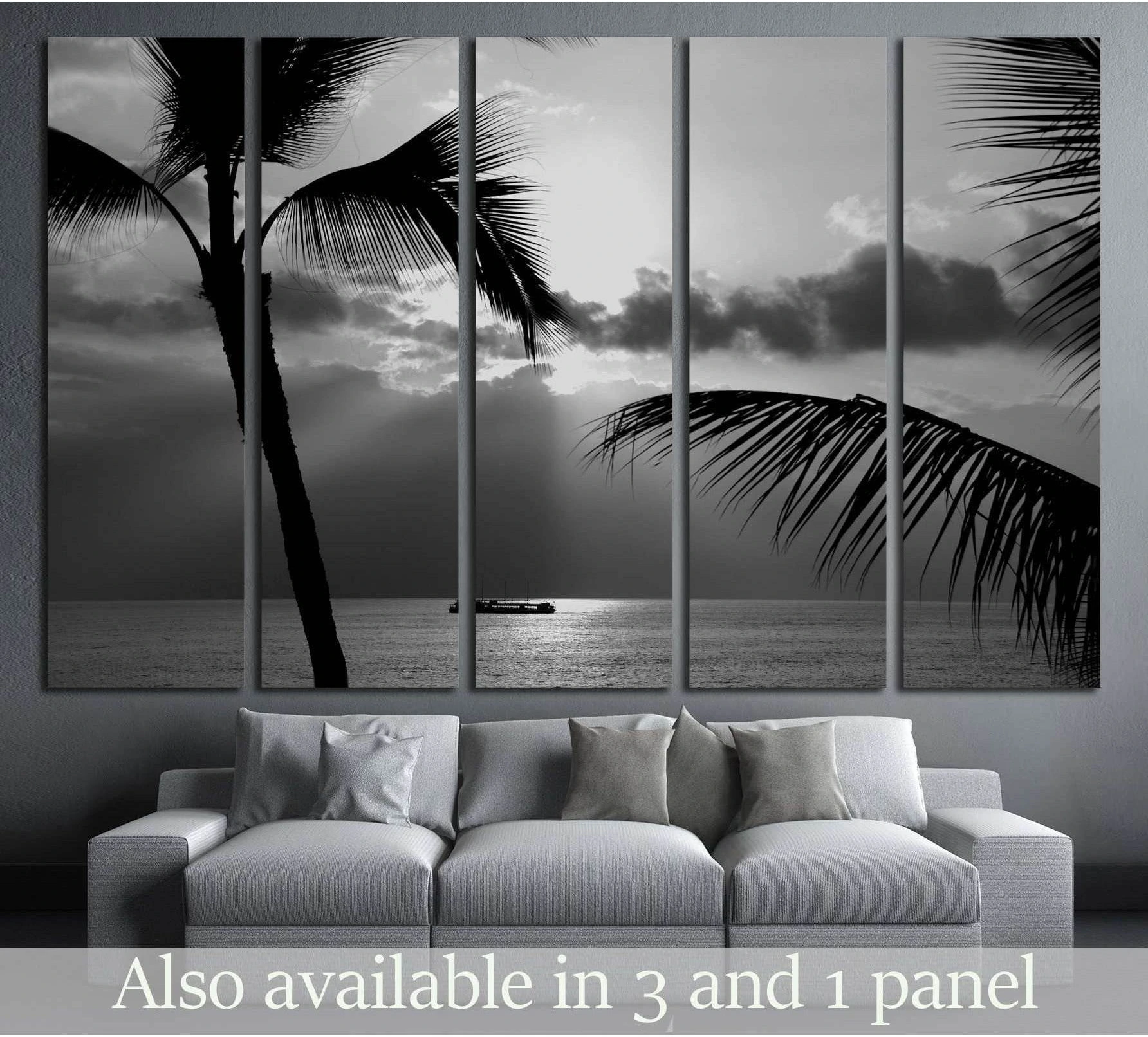 Black and white Kona Coast canvas print with palm silhouettes and a boat on the horizon above a sofa