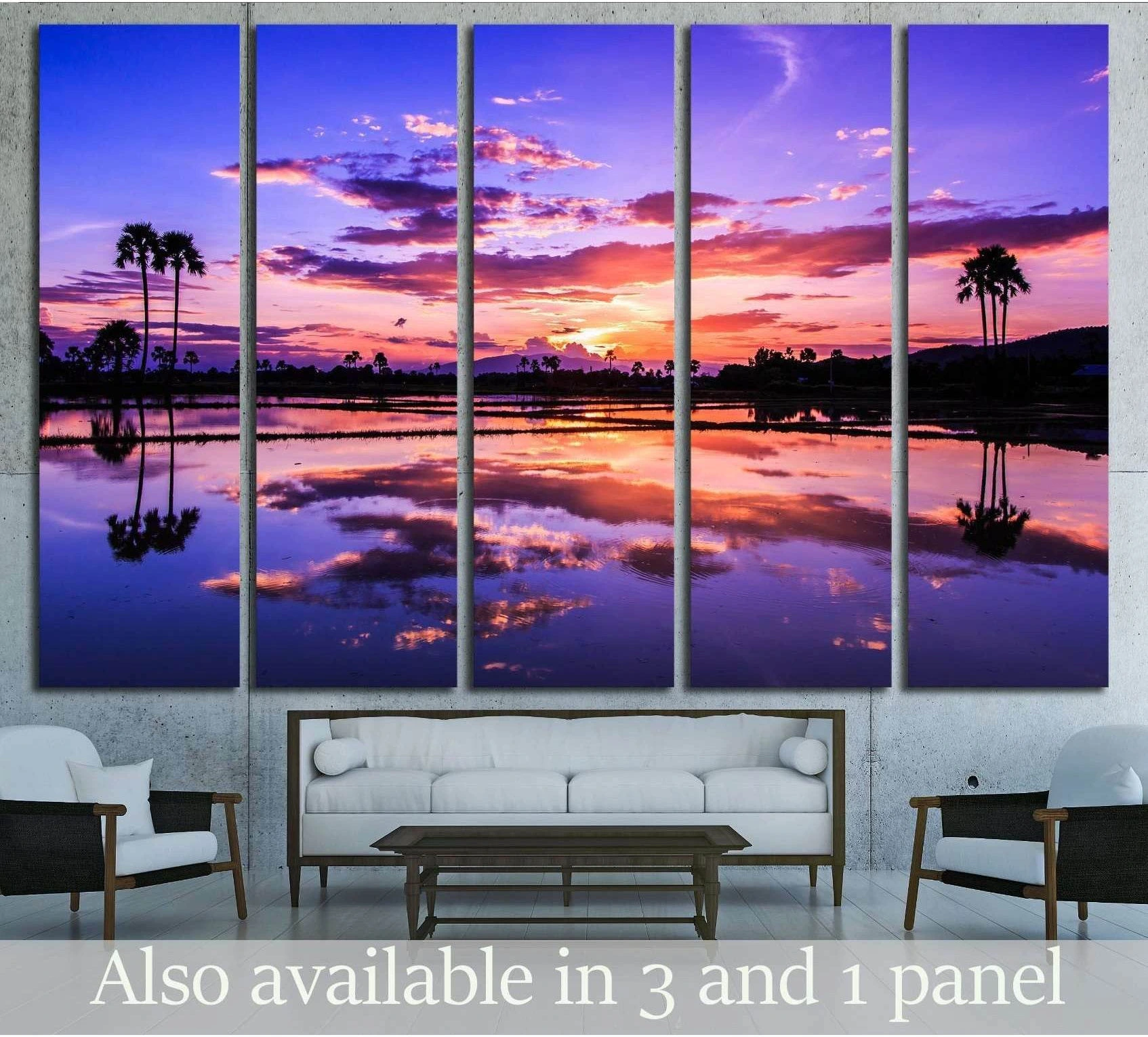 Palm tree sunset canvas print with purple sky and water reflections hung above a sofa