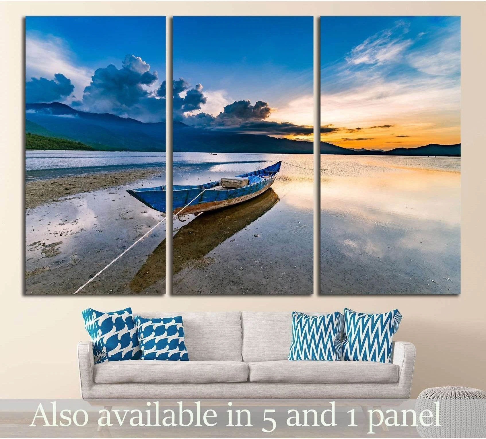Triptych Lap An Lagoon canvas print with blue boat at sunset above sofa in a modern living room