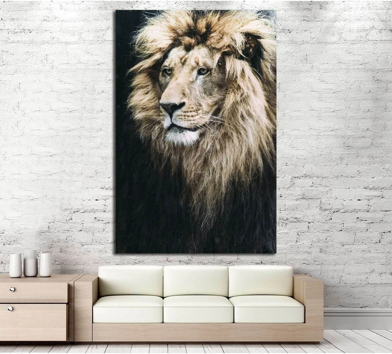 Lion portrait canvas print with dark background and golden mane above sofa in modern living room